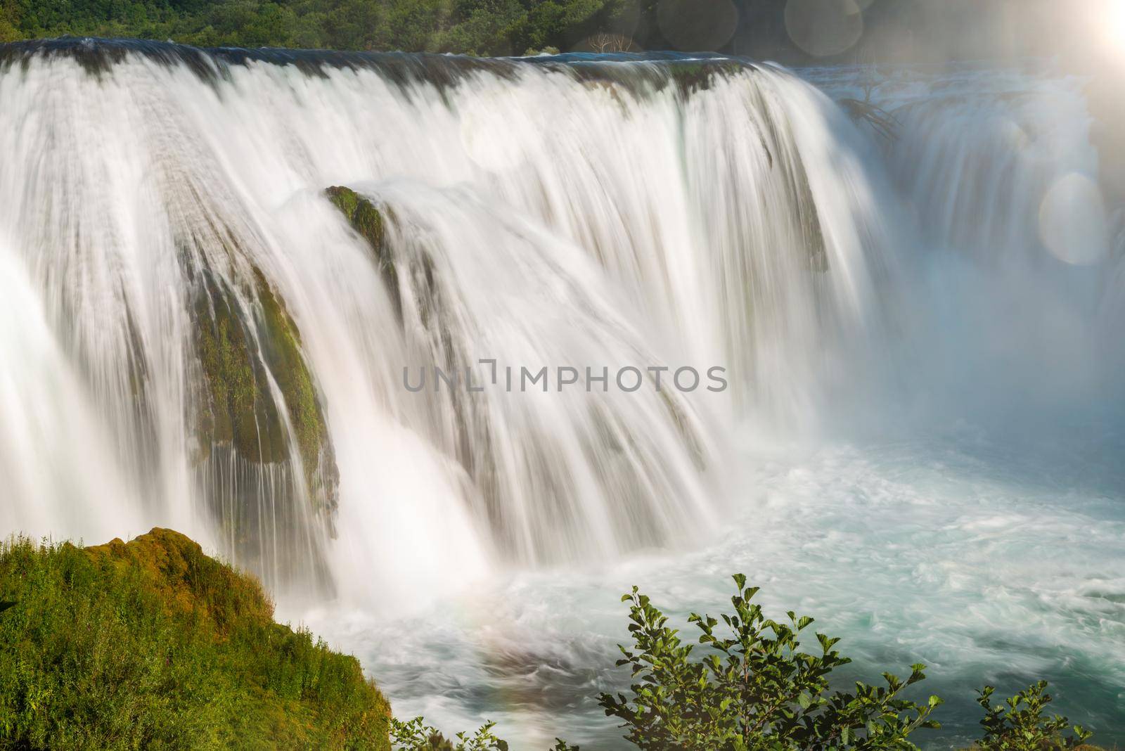 waterfall in beautiful nature with crystal clear water on wild river una in bosnia and herzegovina at sunny summer day