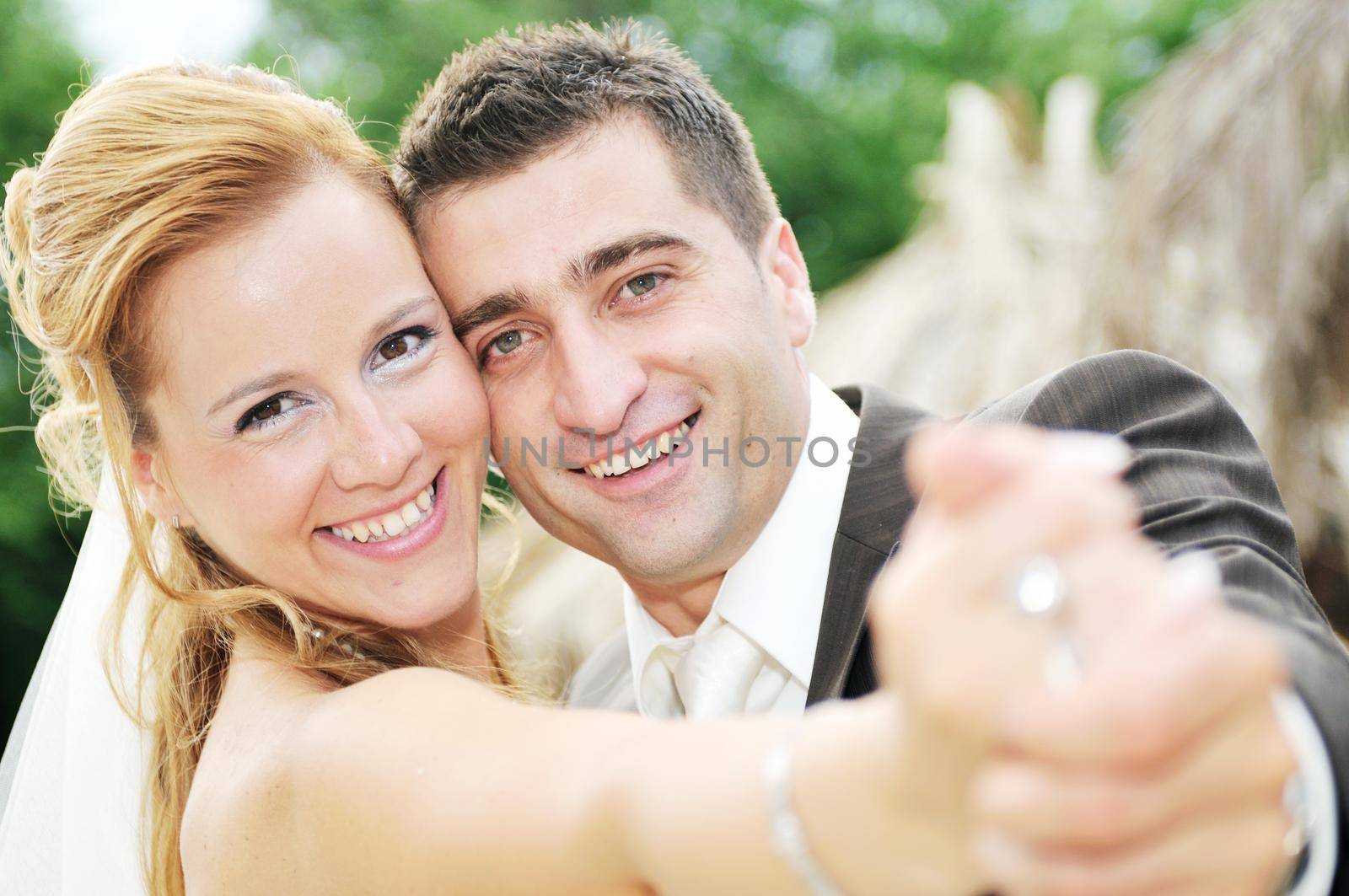 happy young and beautiful bride and groom at wedding party  outdoor