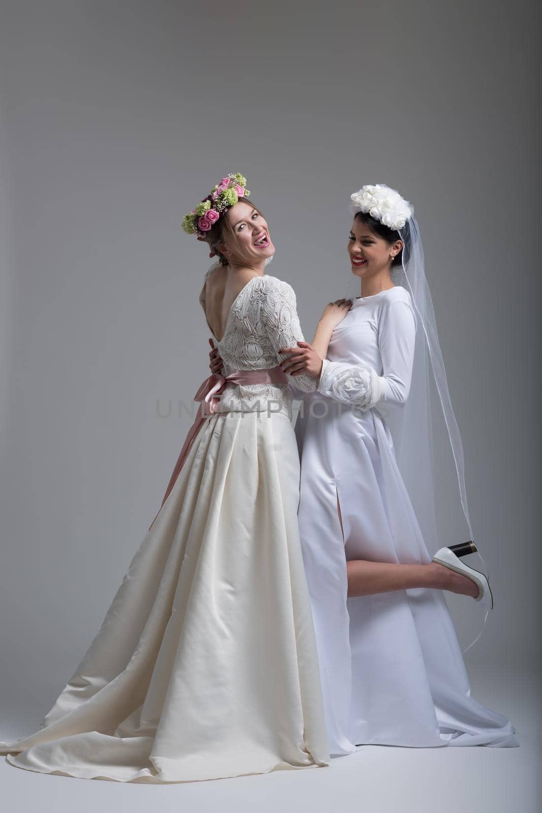 Portrait of two beautiful young bride in wedding dresses by dotshock