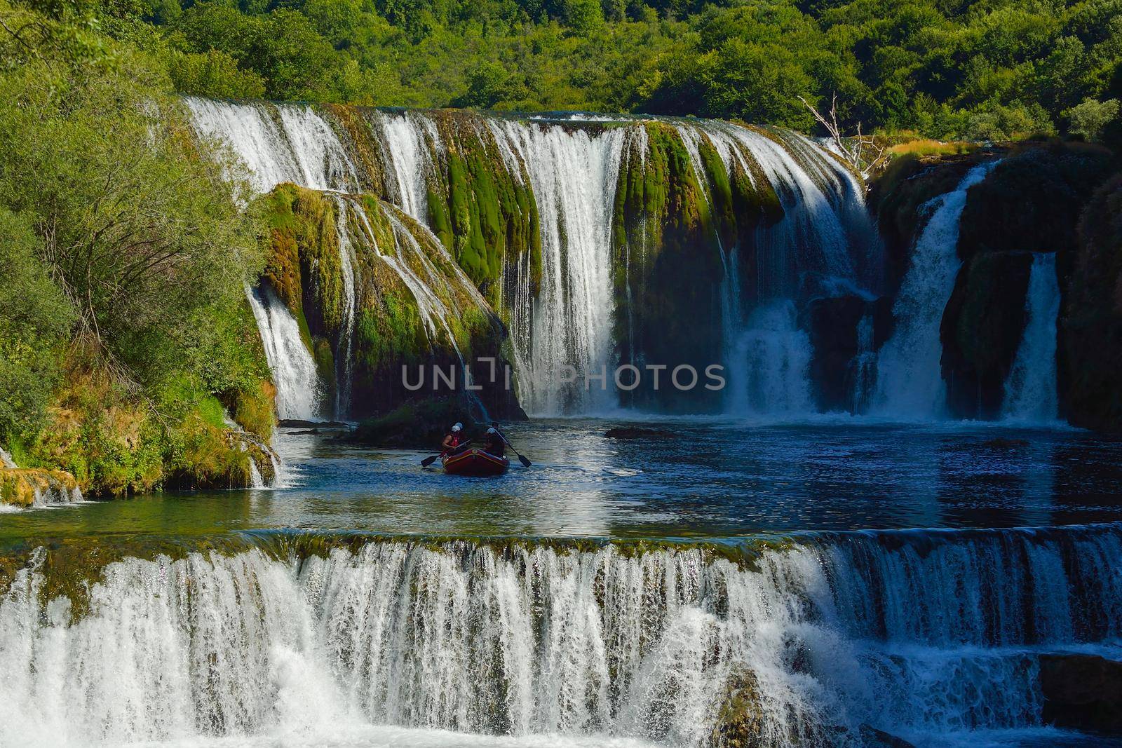 waterfall on wild river with fresh drinking water in summer