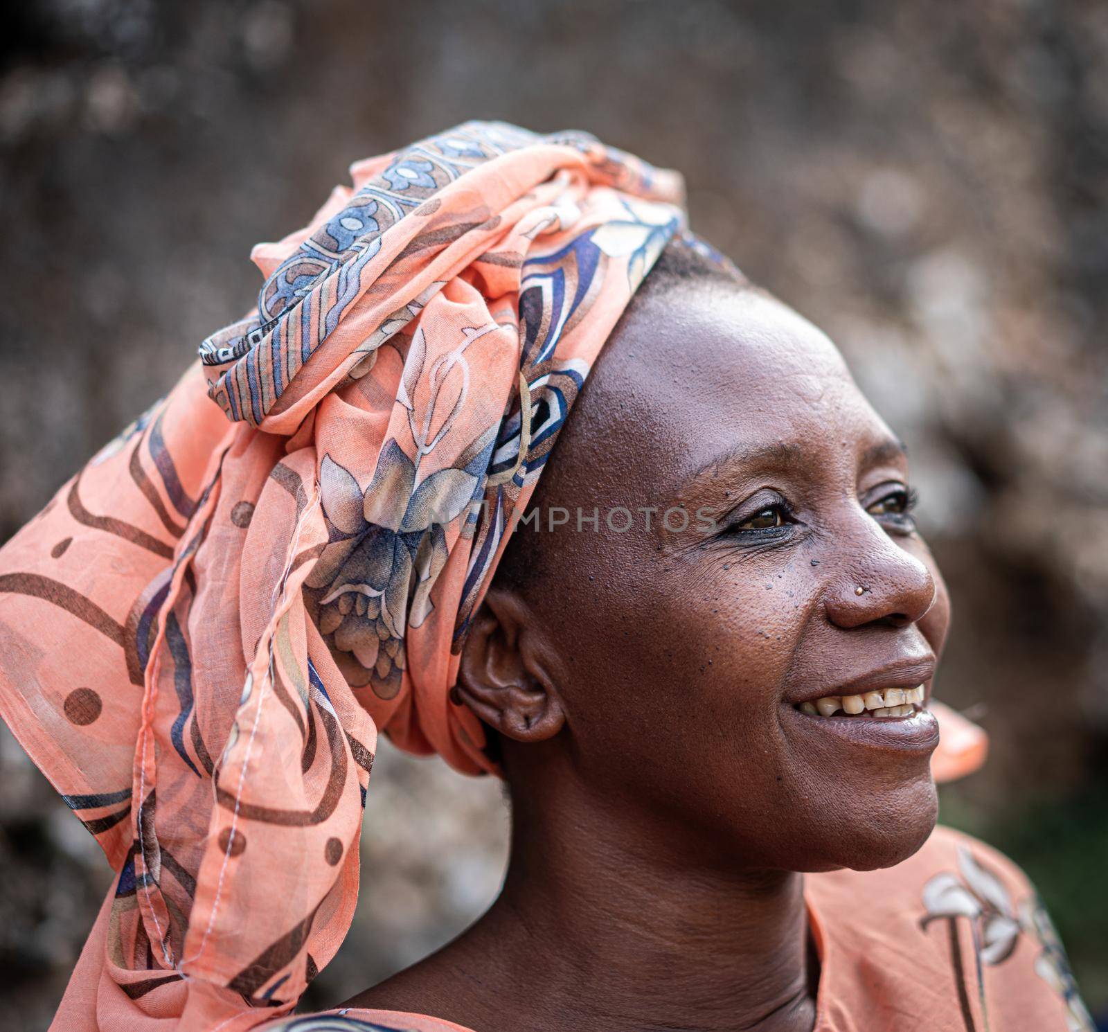 Black African senior beautiful woman with scarf outdoors