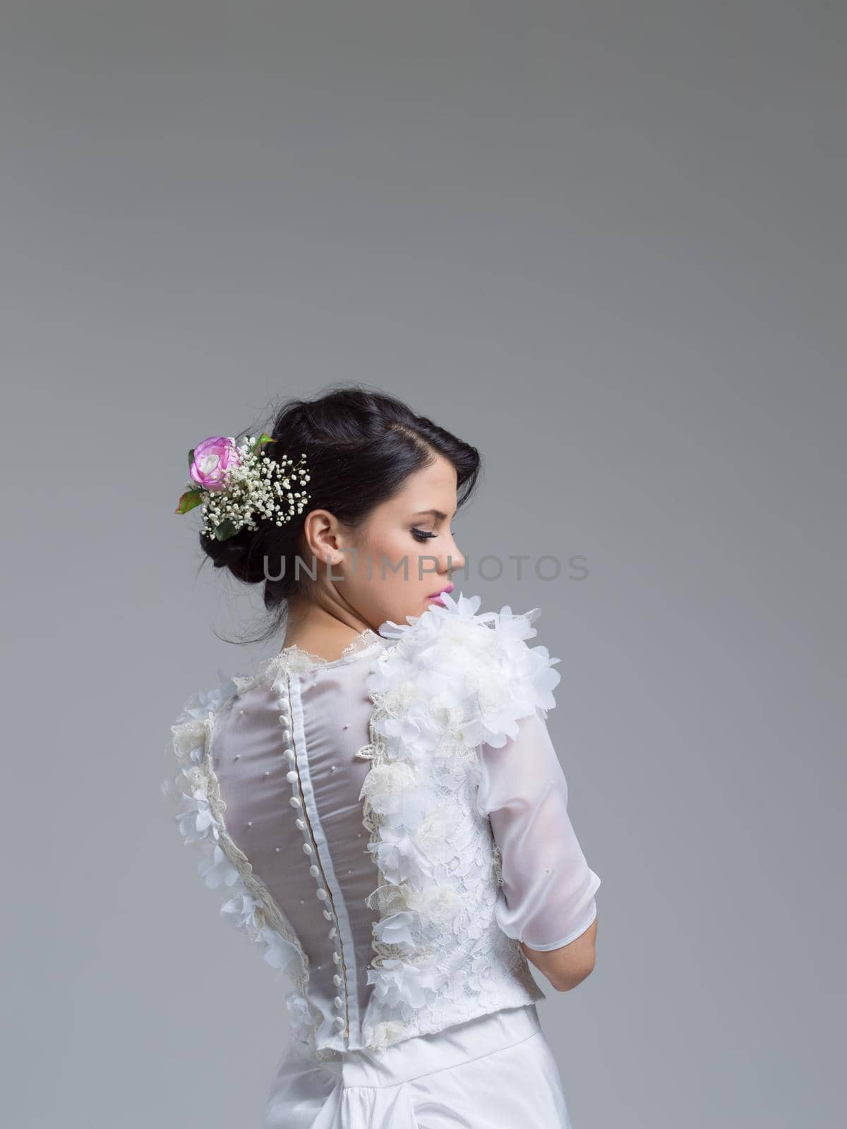Rear view of a beautiful young woman in a wedding dress by dotshock