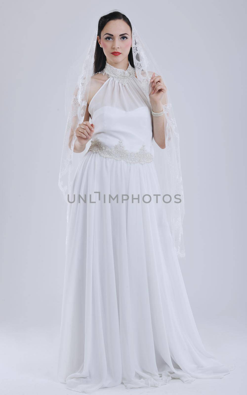 beautiful young bride wearing  wedding dress in retro fashion style isolated on white background in studio