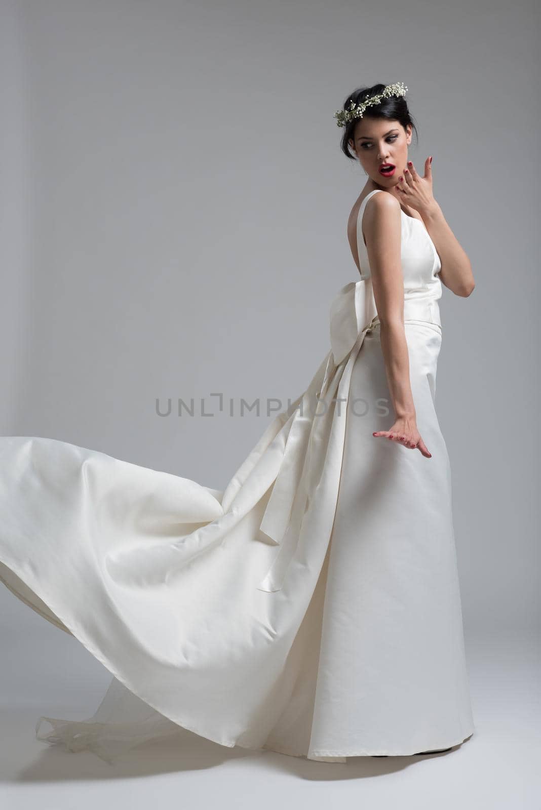 Portrait of beautiful young women in wedding dress isolated on a white background