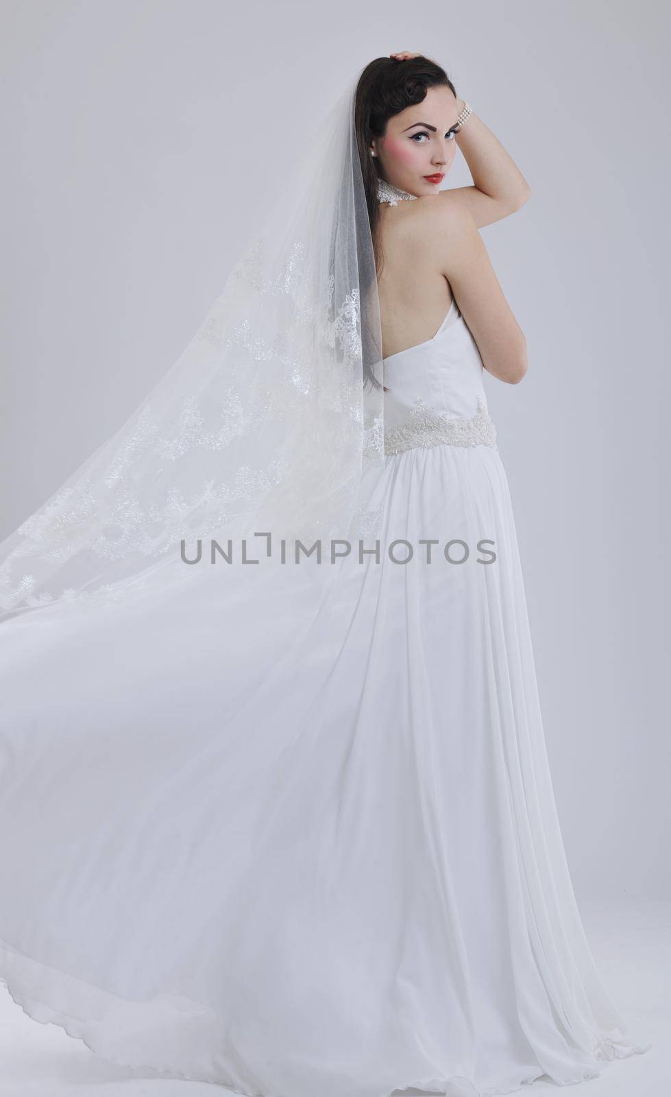 beautiful young bride wearing  wedding dress in retro fashion style isolated on white background in studio