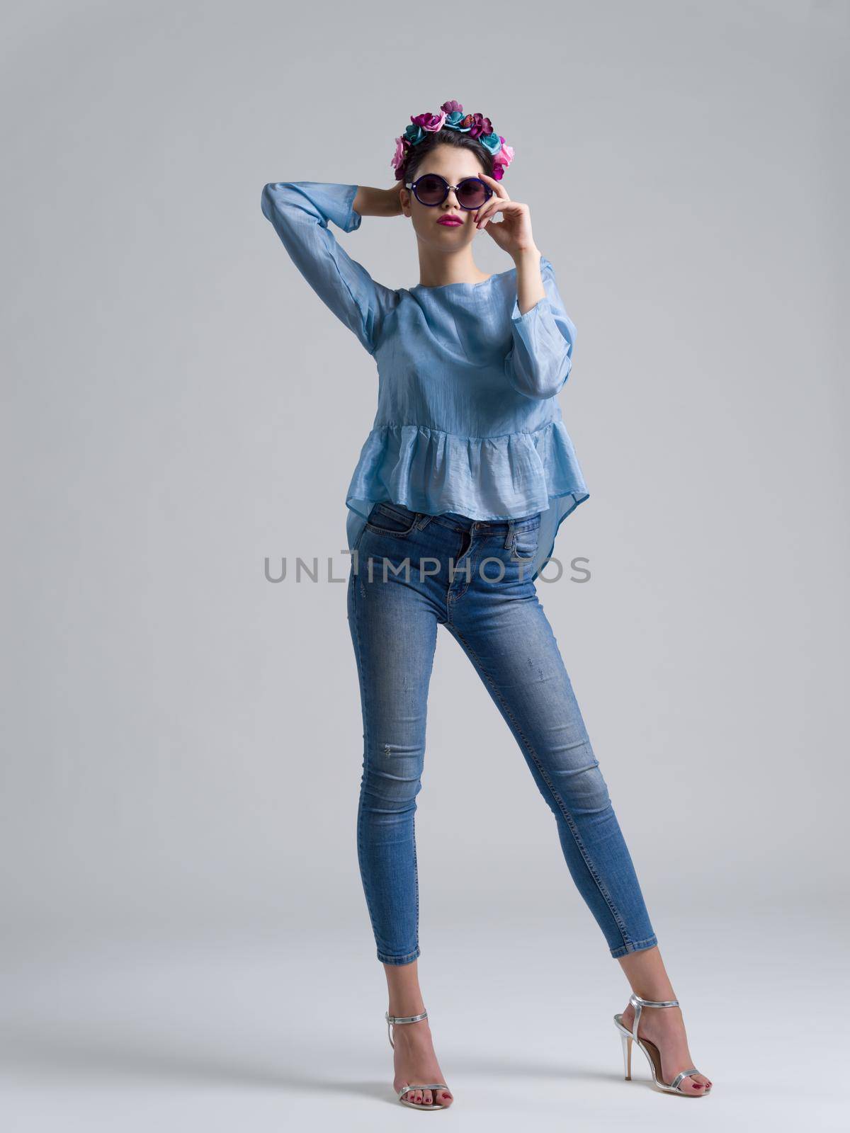Fashion Model girl isolated over white background. Beauty stylish woman posing in fashionable clothes and sunglasses. Casual style with beauty accessories. High fashion urban style