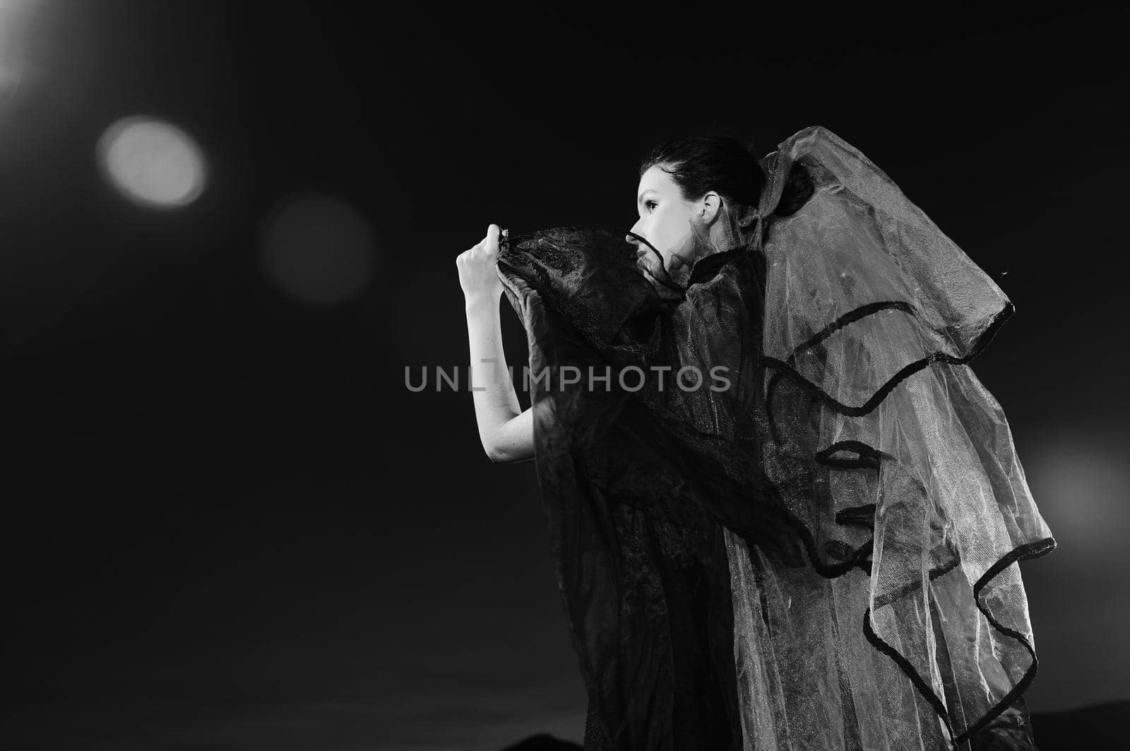 young beautiful bride in black wedding dress in dar at night 