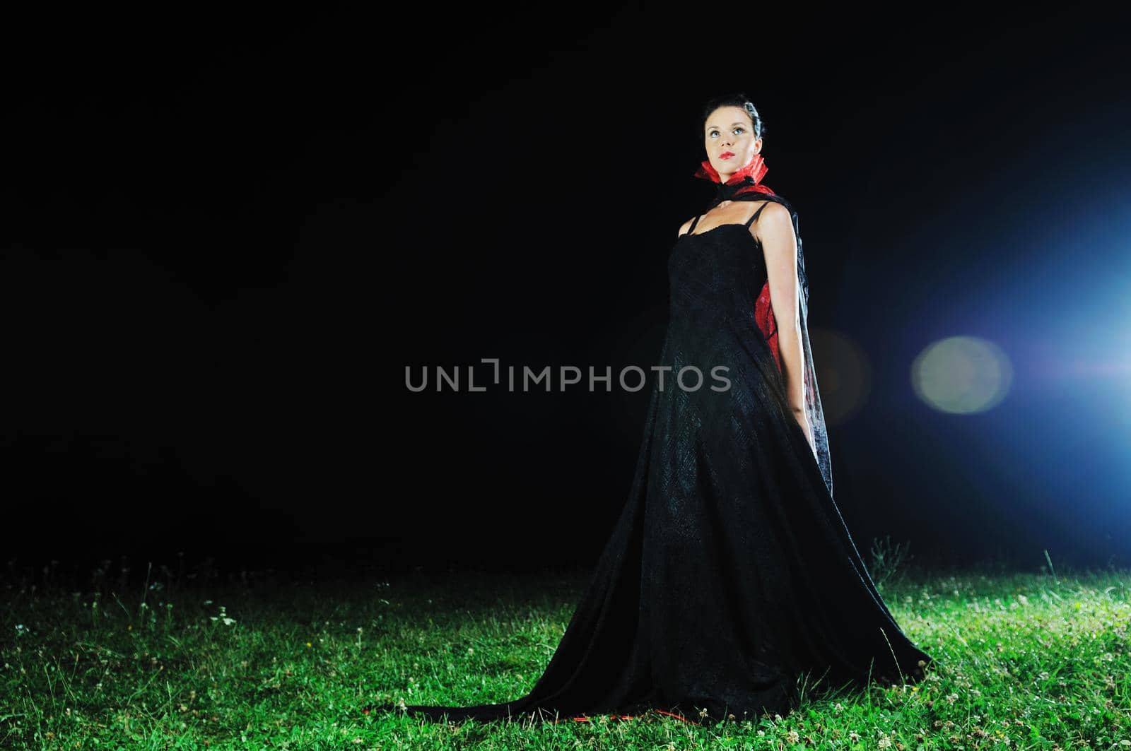 young beautiful bride in black wedding dress in dar at night 