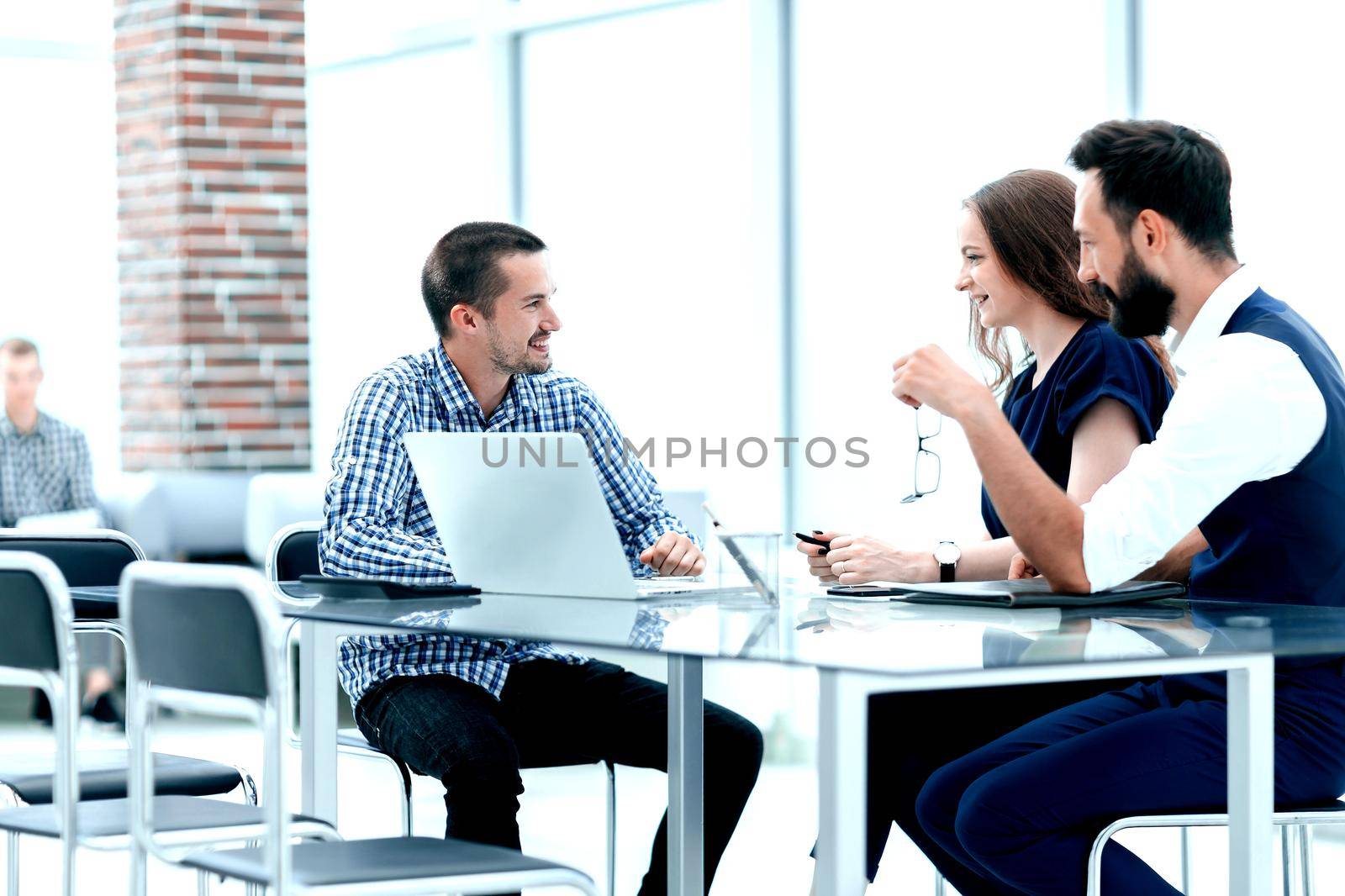 business team discussing something sitting at the office table.the concept of a startup