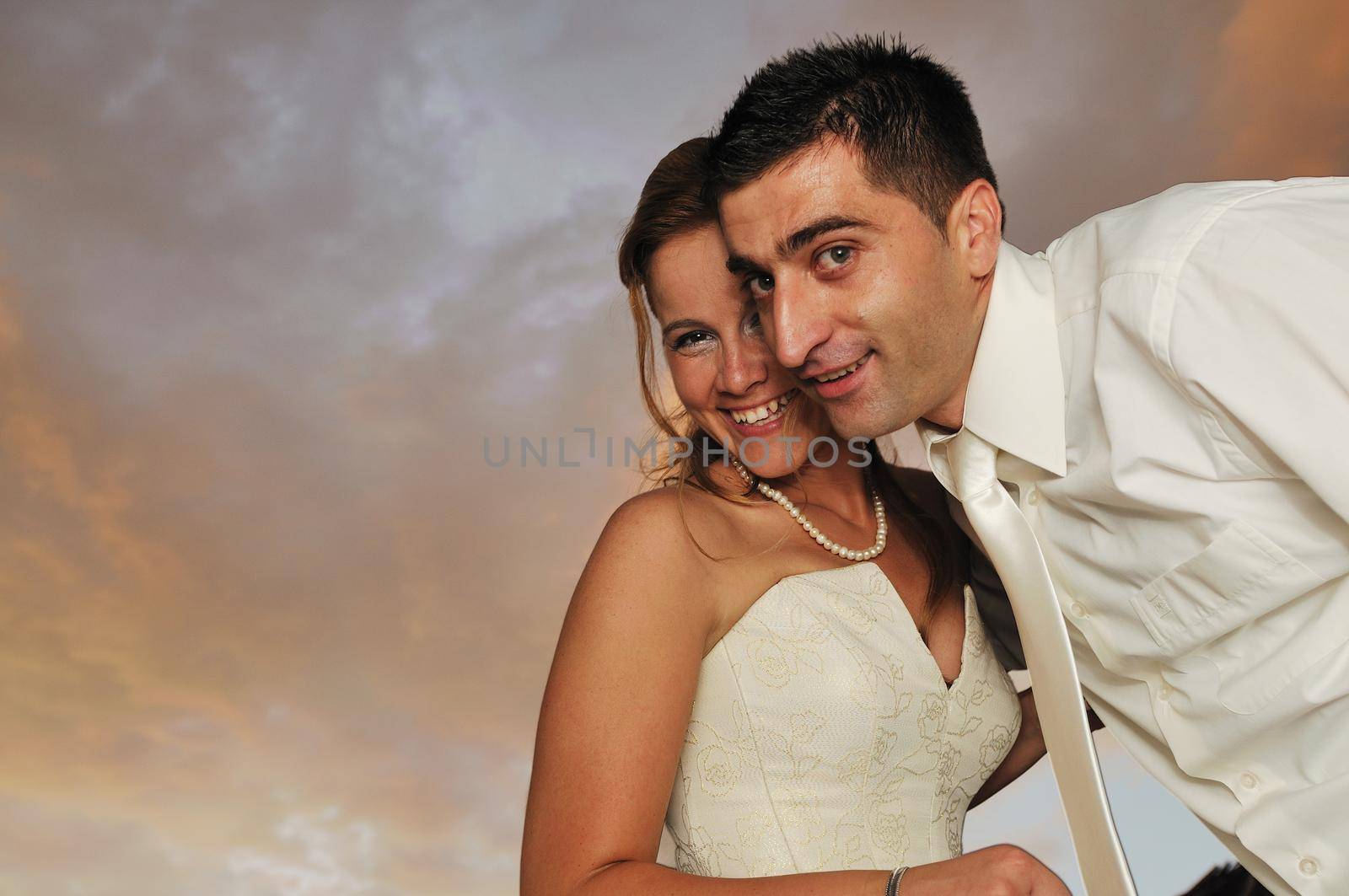happy young and beautiful bride and groom at wedding party  outdoor