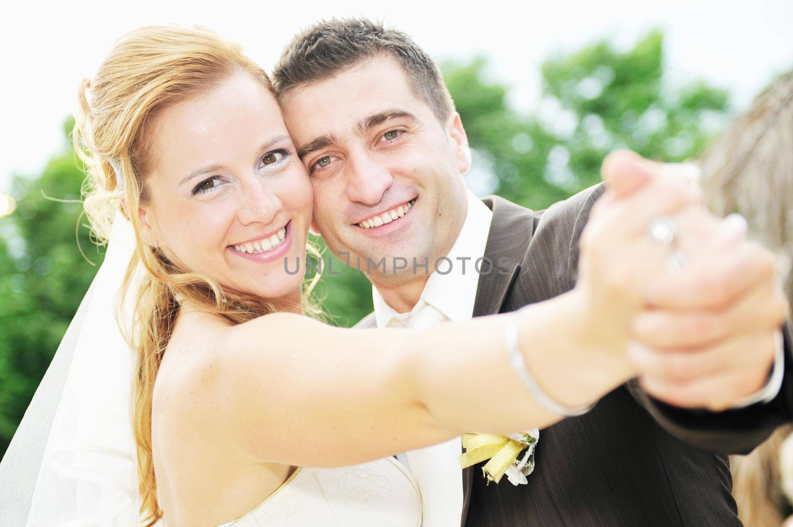 happy young and beautiful bride and groom at wedding party  outdoor