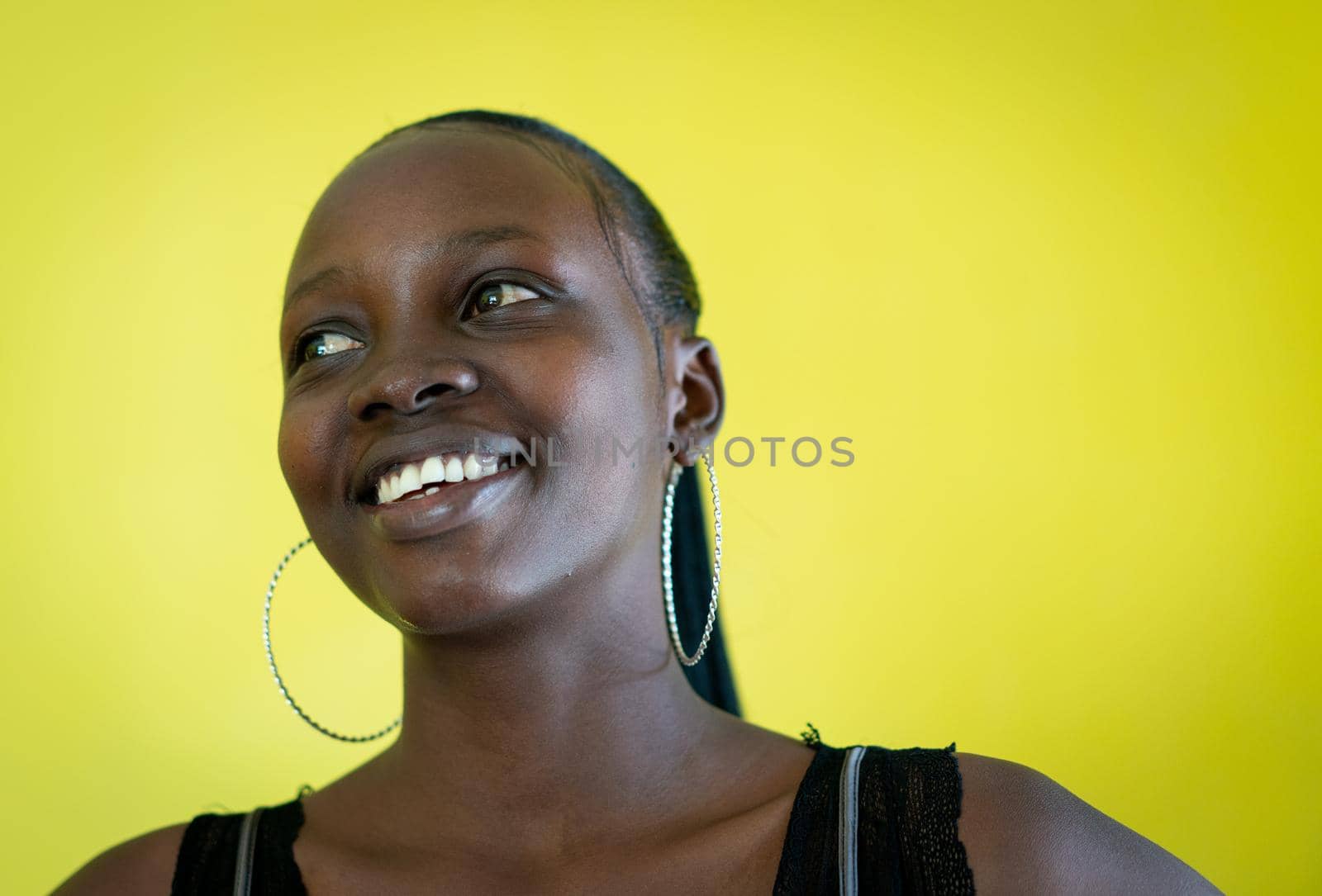 Beautiful dark skin young woman portrait on yellow