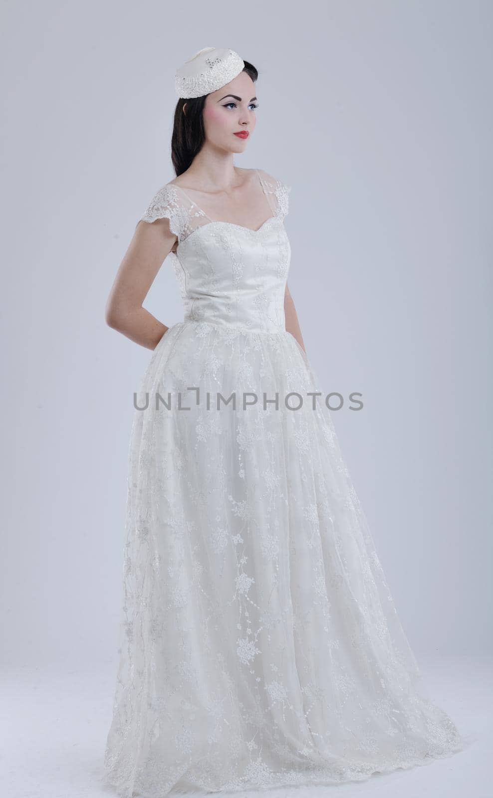 beautiful young bride wearing  wedding dress in retro fashion style isolated on white background in studio