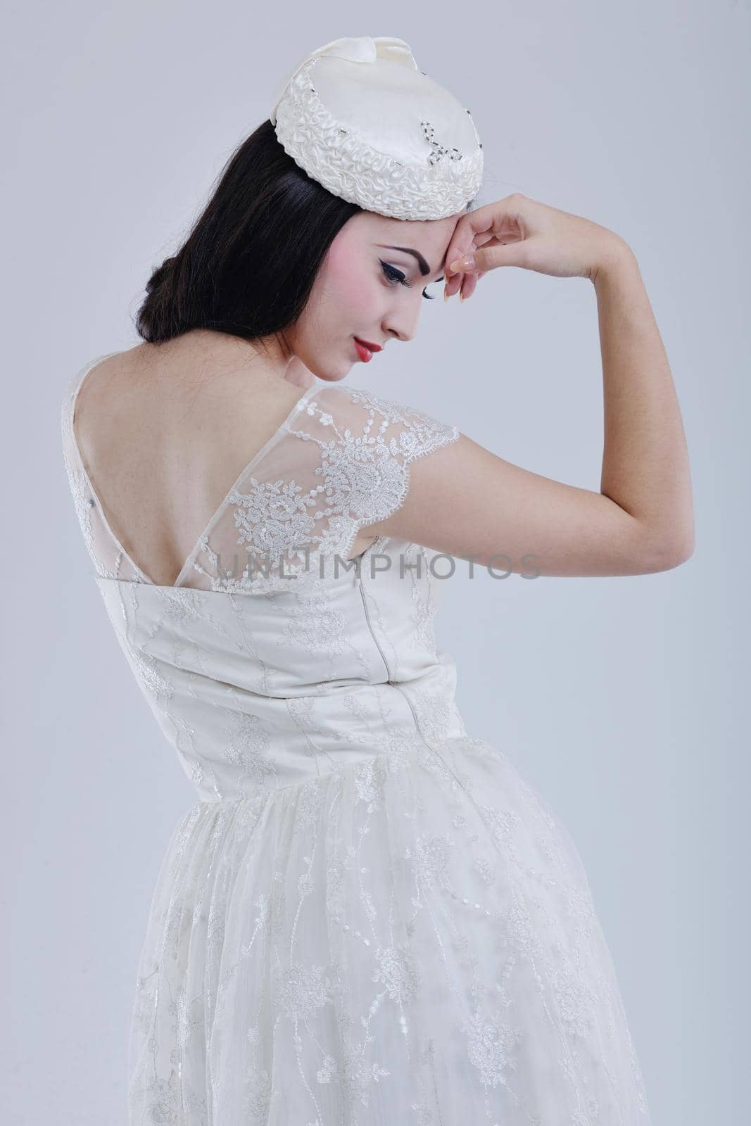 beautiful young bride wearing  wedding dress in retro fashion style isolated on white background in studio