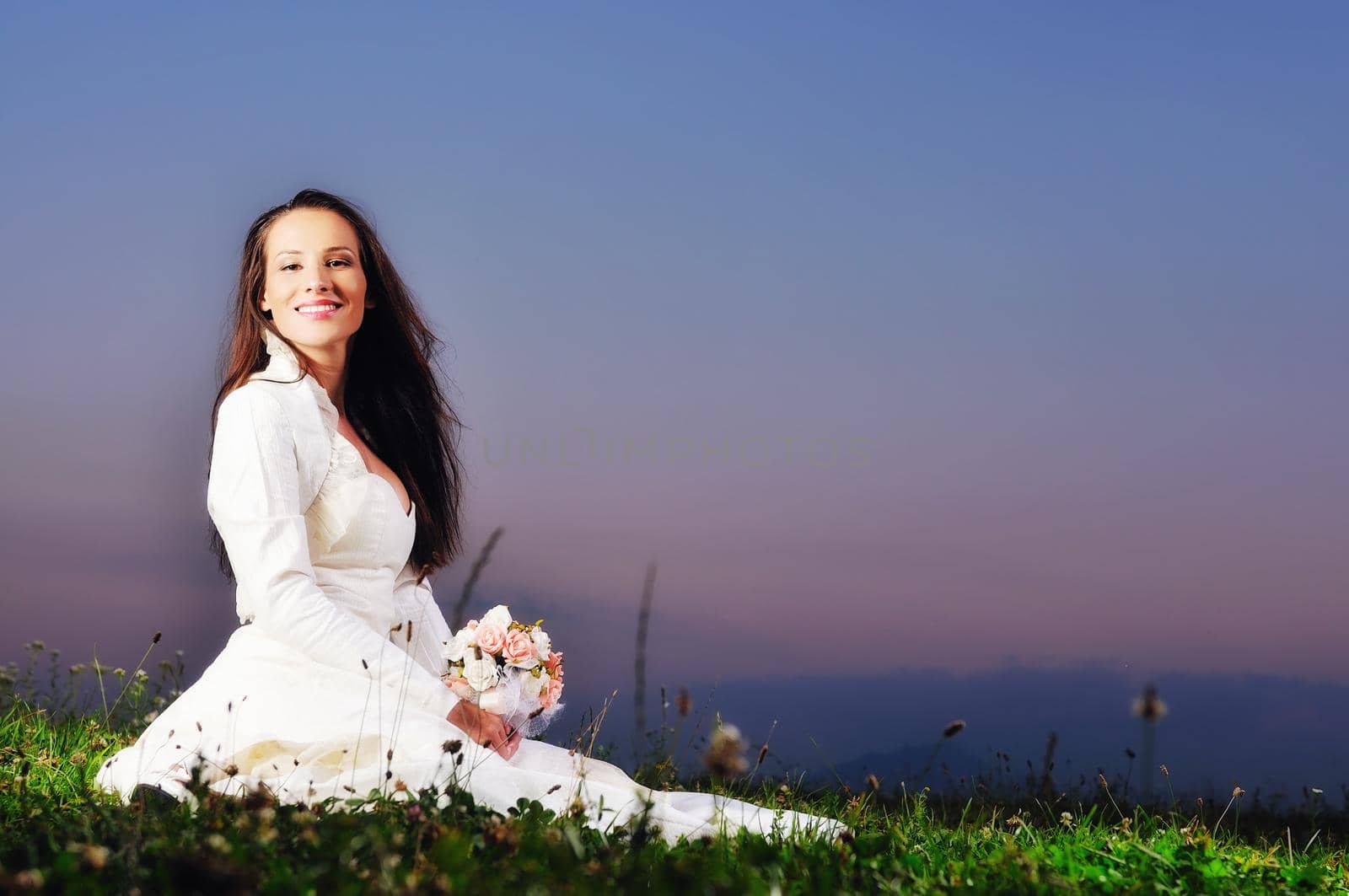 happy young beautiful bride after wedding ceremony event have fun on meadow in fashionable wedding dress