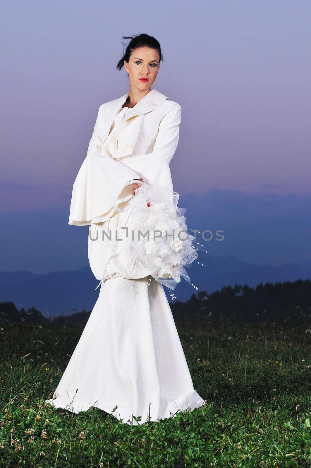 happy young beautiful bride after wedding ceremony event have fun on meadow in fashionable wedding dress