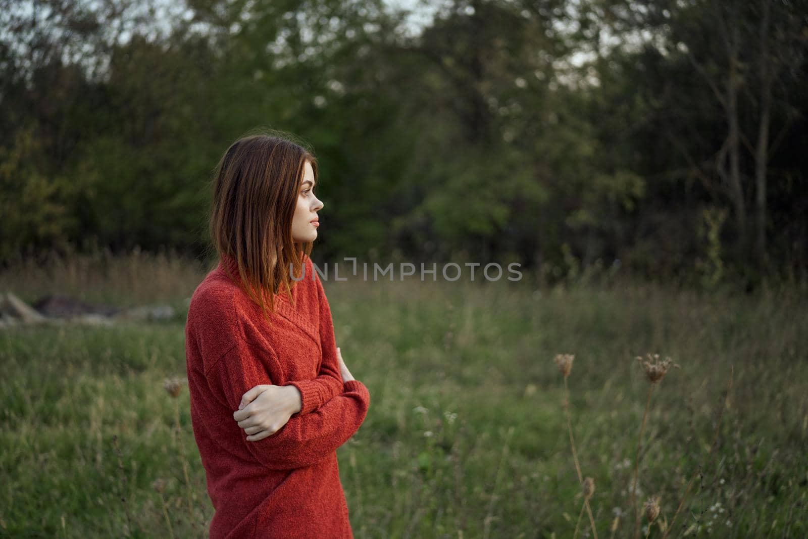 woman in a red sweater outdoors in the field nature rest by Vichizh