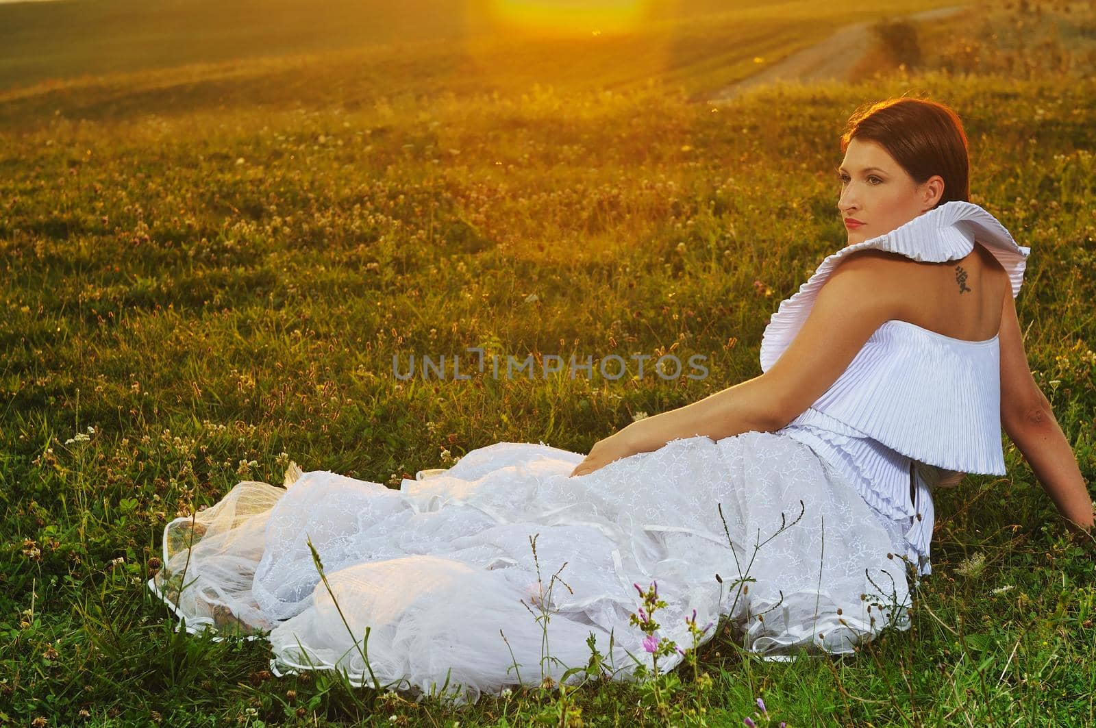 happy young beautiful bride after wedding ceremony event have fun on meadow in fashionable wedding dress