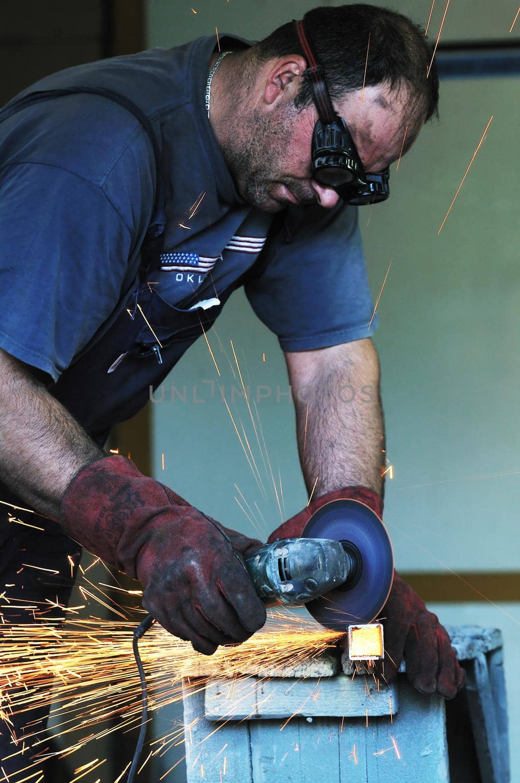 industry worker cut steel with spinning machine and spark