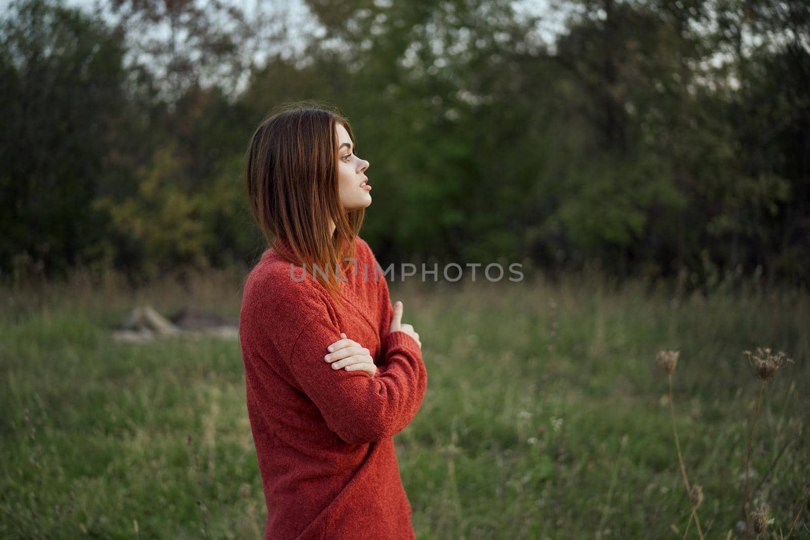 woman in a red sweater outdoors in the field nature rest by Vichizh