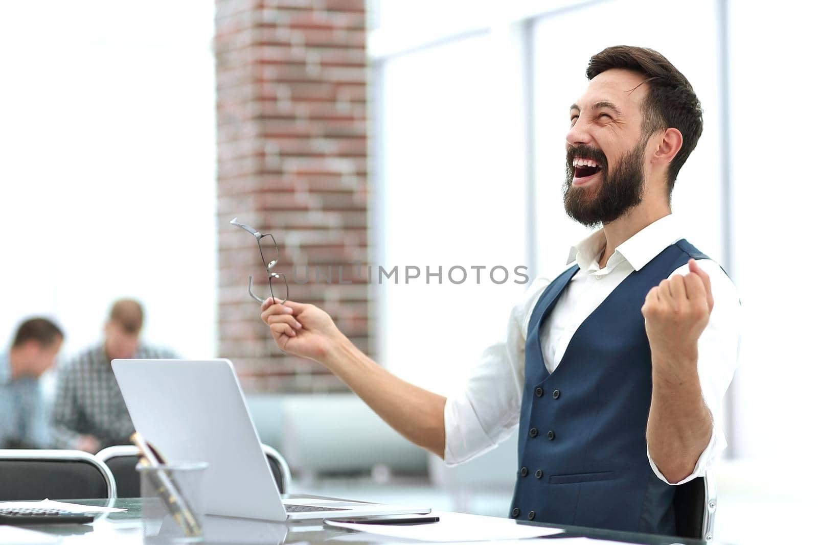 happy businessman sitting at the office Desk. photo with copy space