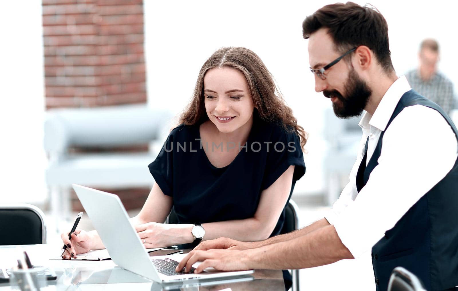 business colleagues using a laptop in the workplace. people and technology