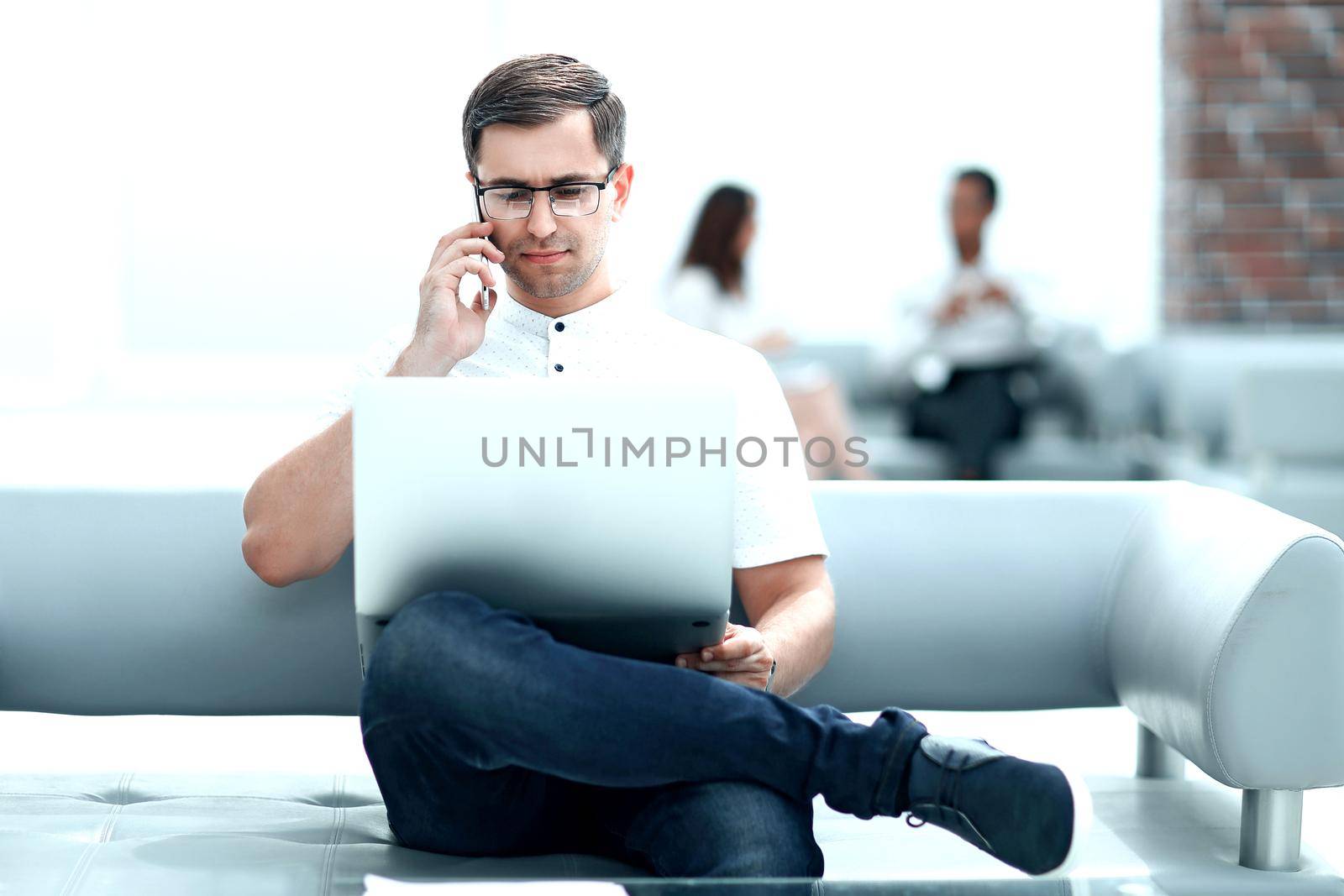 modern man sitting in the lobby of a modern hotel . photo with copy space