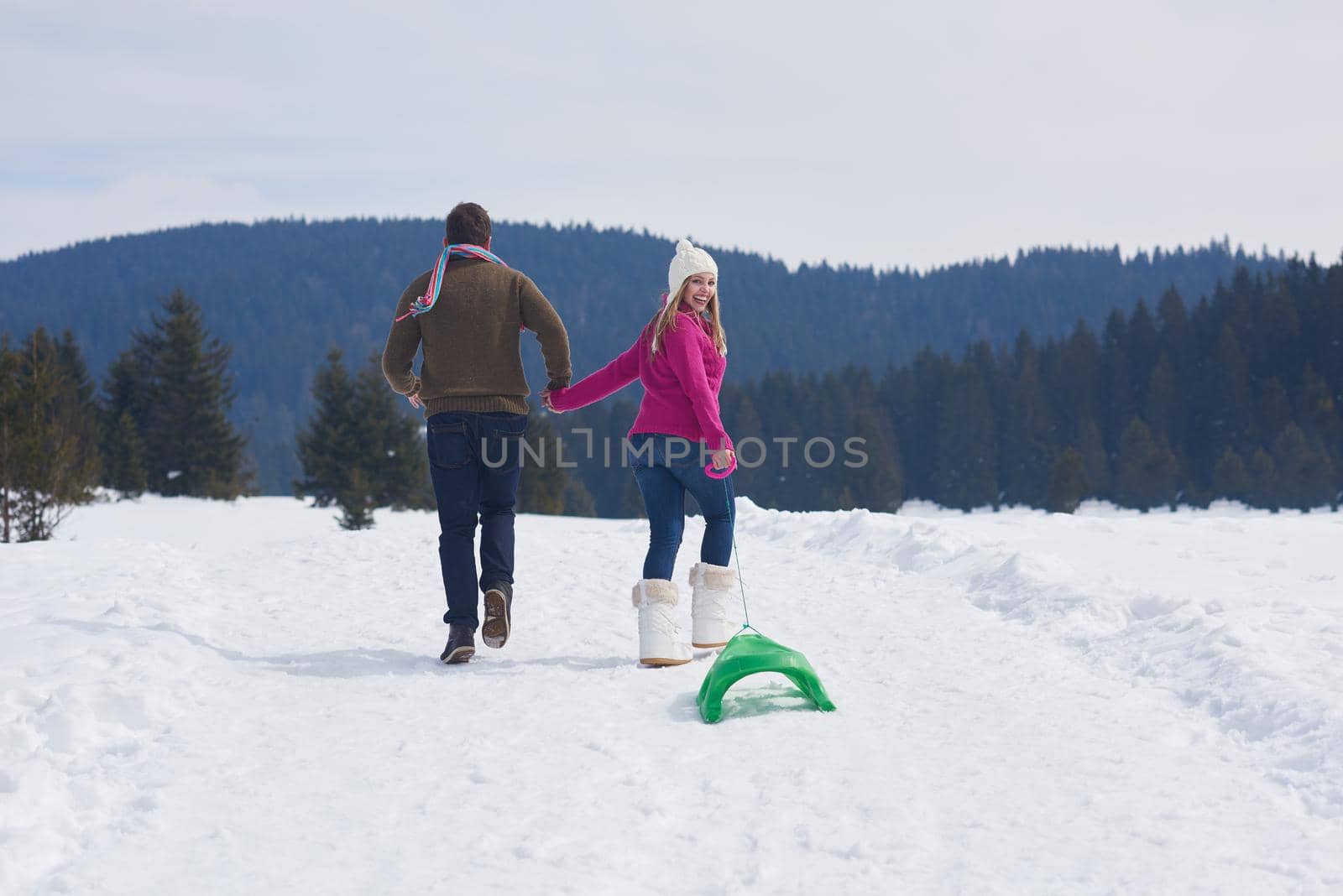 romantic winter  scene, happy young couple having fun on fresh show on winter vacatio, mountain nature landscape