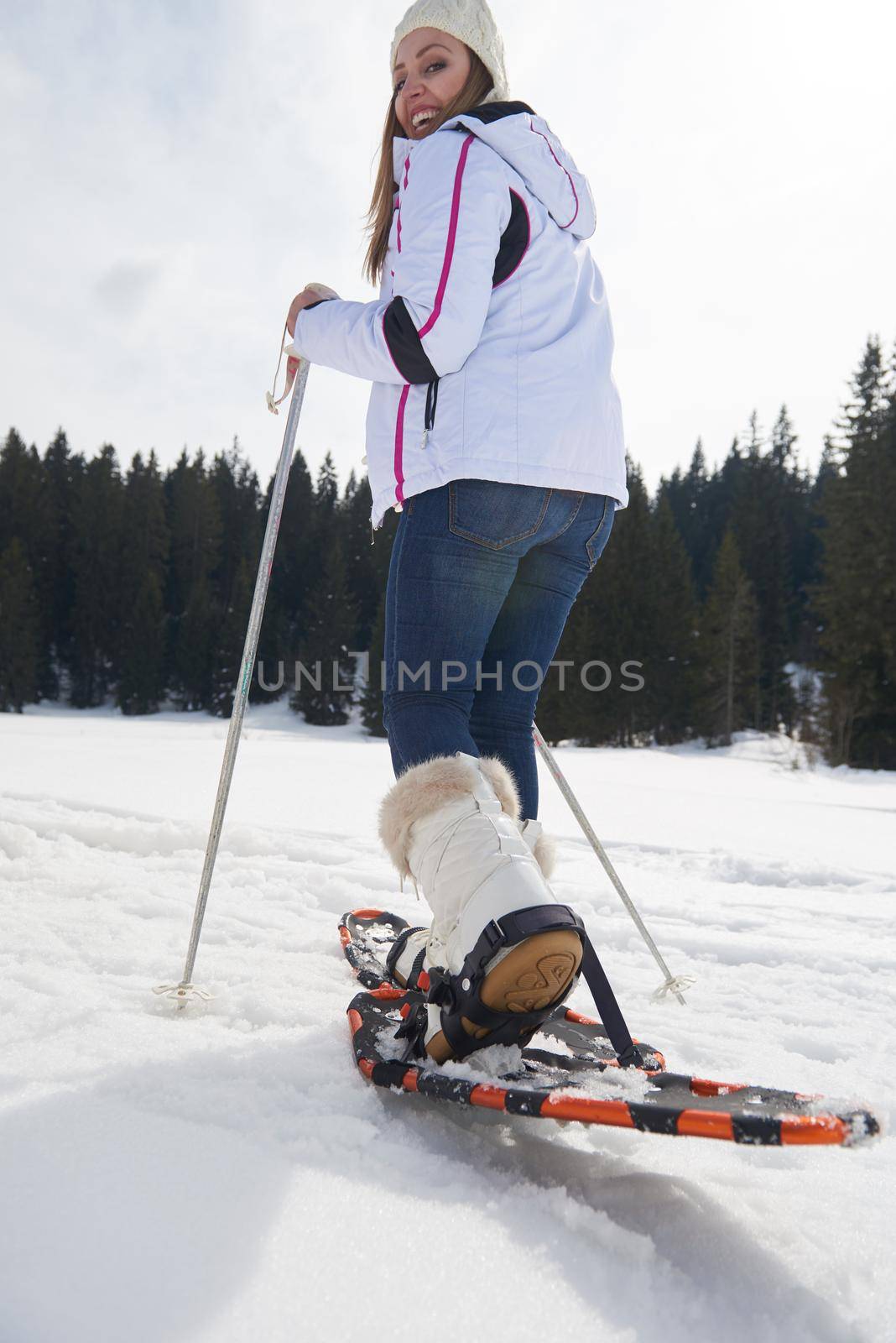 couple having fun and walking in snow shoes by dotshock