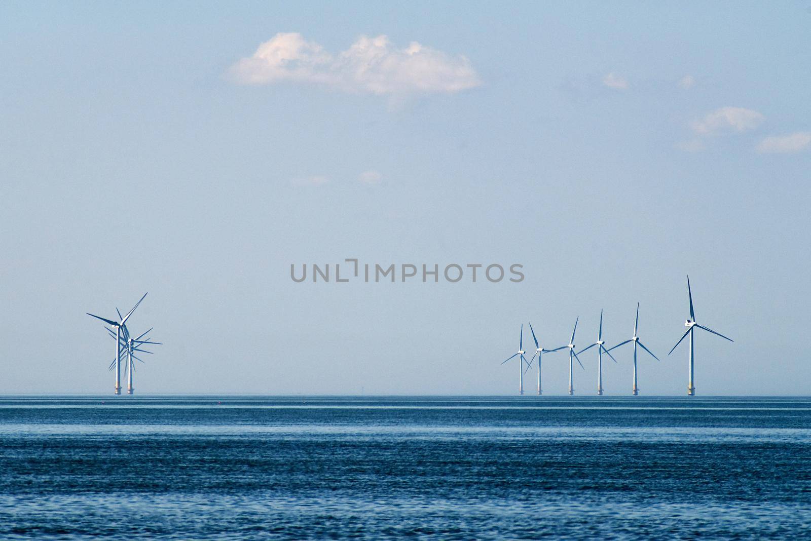 Tall white wind turbines in the distance