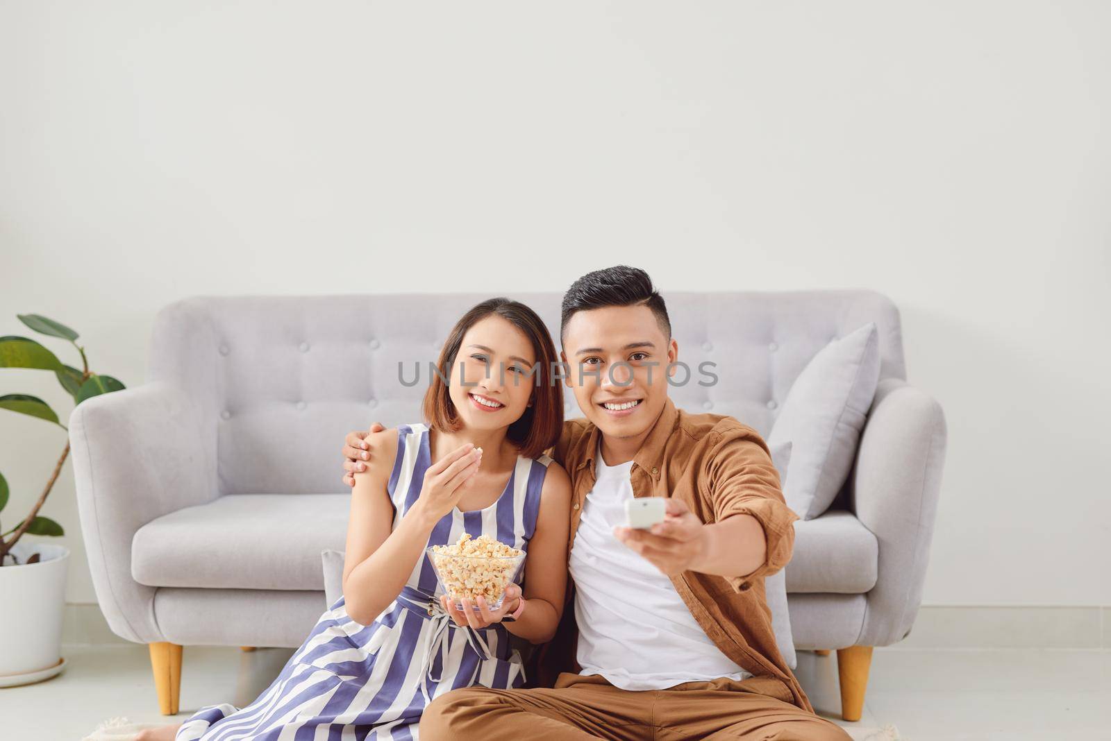 Young couple preparing to watch a movie