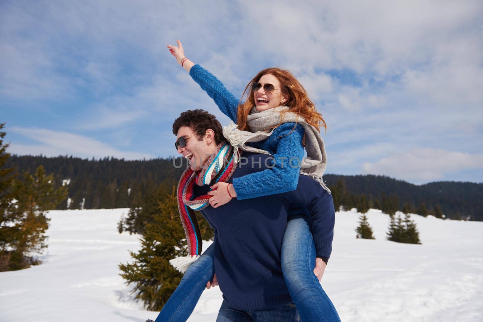 romantic winter  scene, happy young couple having fun on fresh show on winter vacatio, mountain nature landscape