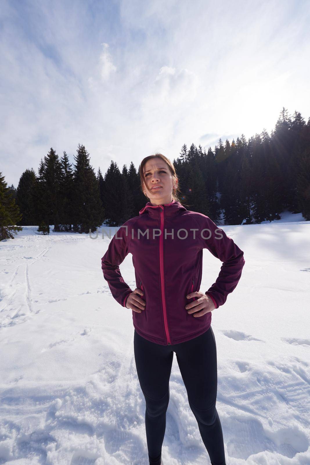 yougn woman jogging outdoor on snow in forest, healthy winter lifestyle and recreation