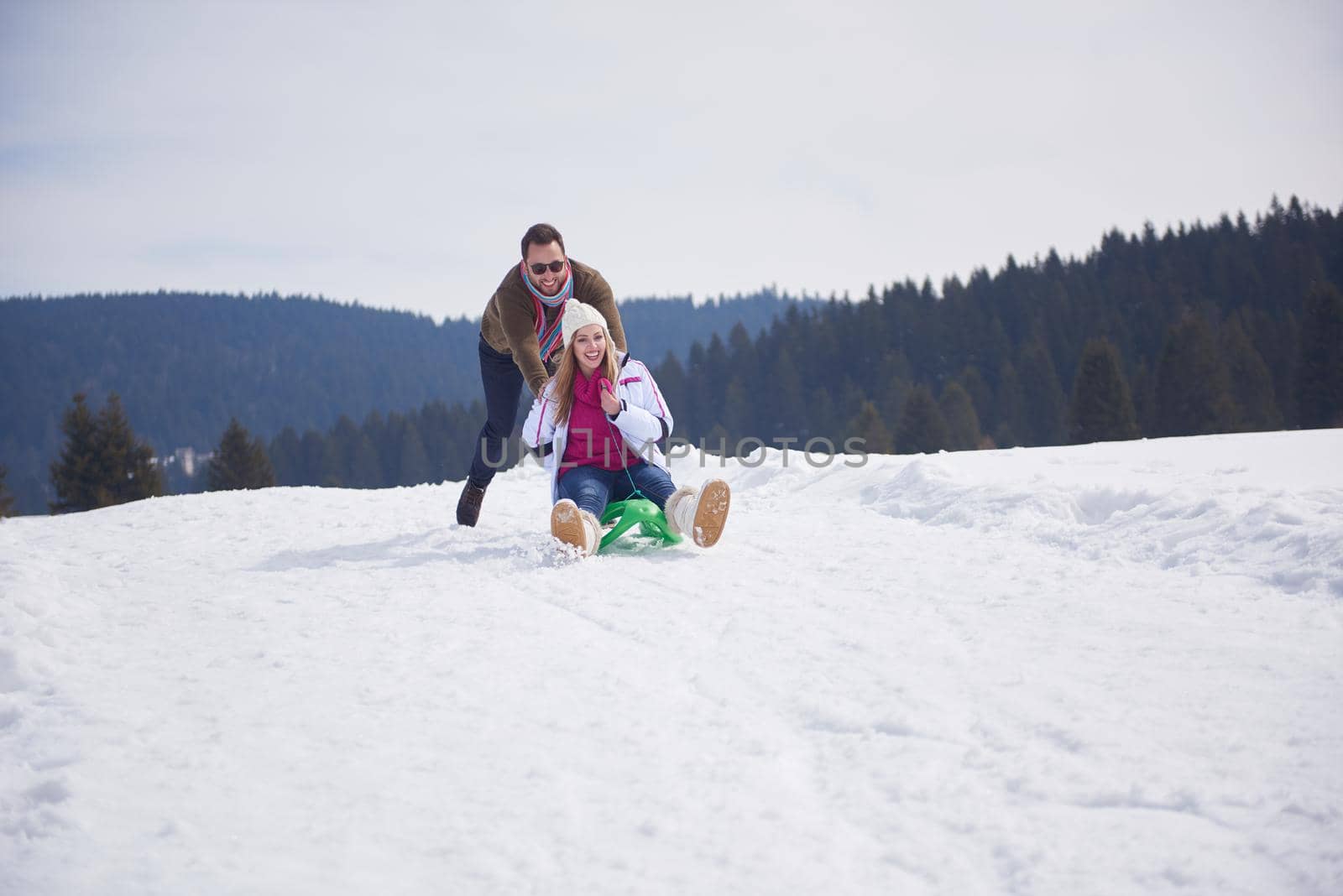 romantic winter  scene, happy young couple having fun on fresh show on winter vacatio, mountain nature landscape