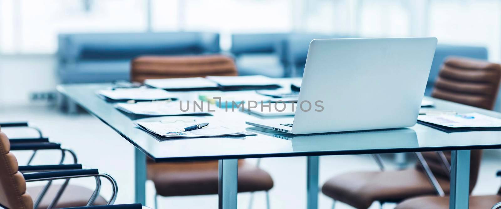 laptop and documents on the desktop in the accounting Department of the company by SmartPhotoLab