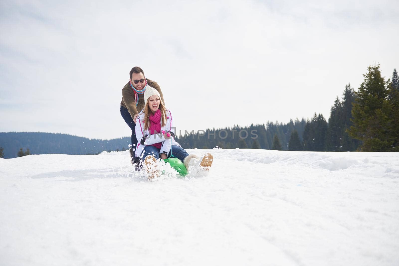 romantic winter  scene, happy young couple having fun on fresh show on winter vacatio, mountain nature landscape