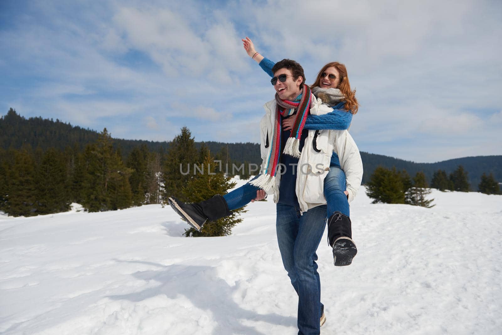 romantic winter  scene, happy young couple having fun on fresh show on winter vacatio, mountain nature landscape