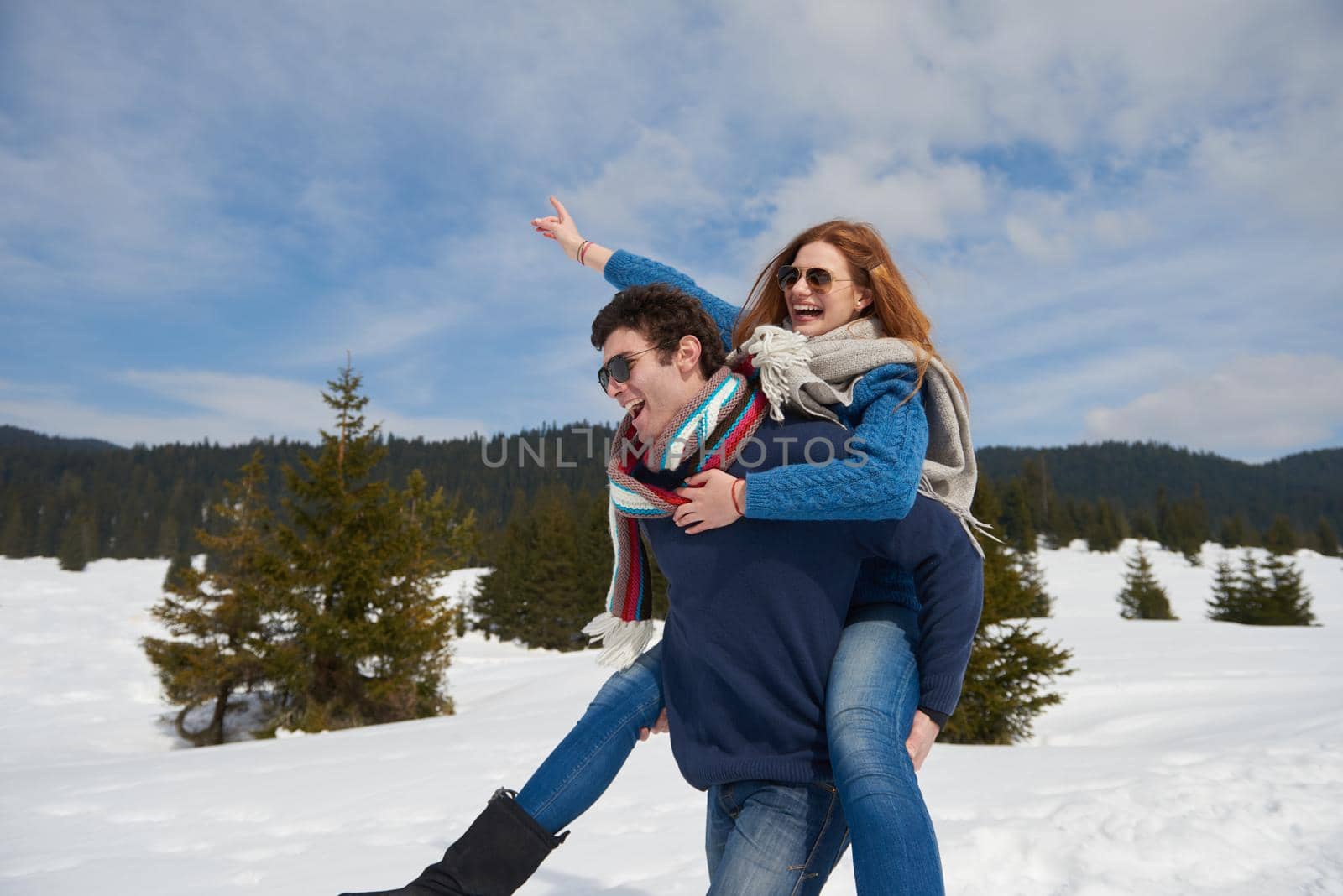 romantic winter  scene, happy young couple having fun on fresh show on winter vacatio, mountain nature landscape