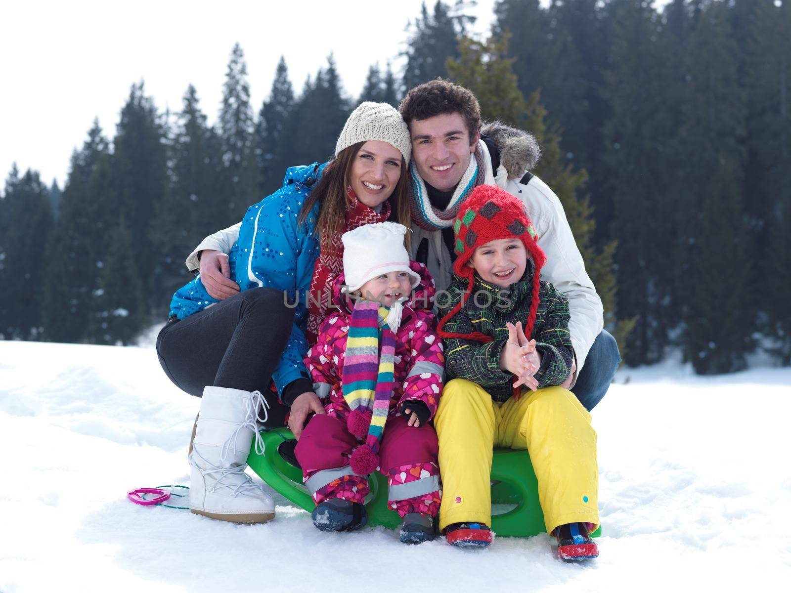 Winter playing, fun, snow and family portrait  sledding at winter time