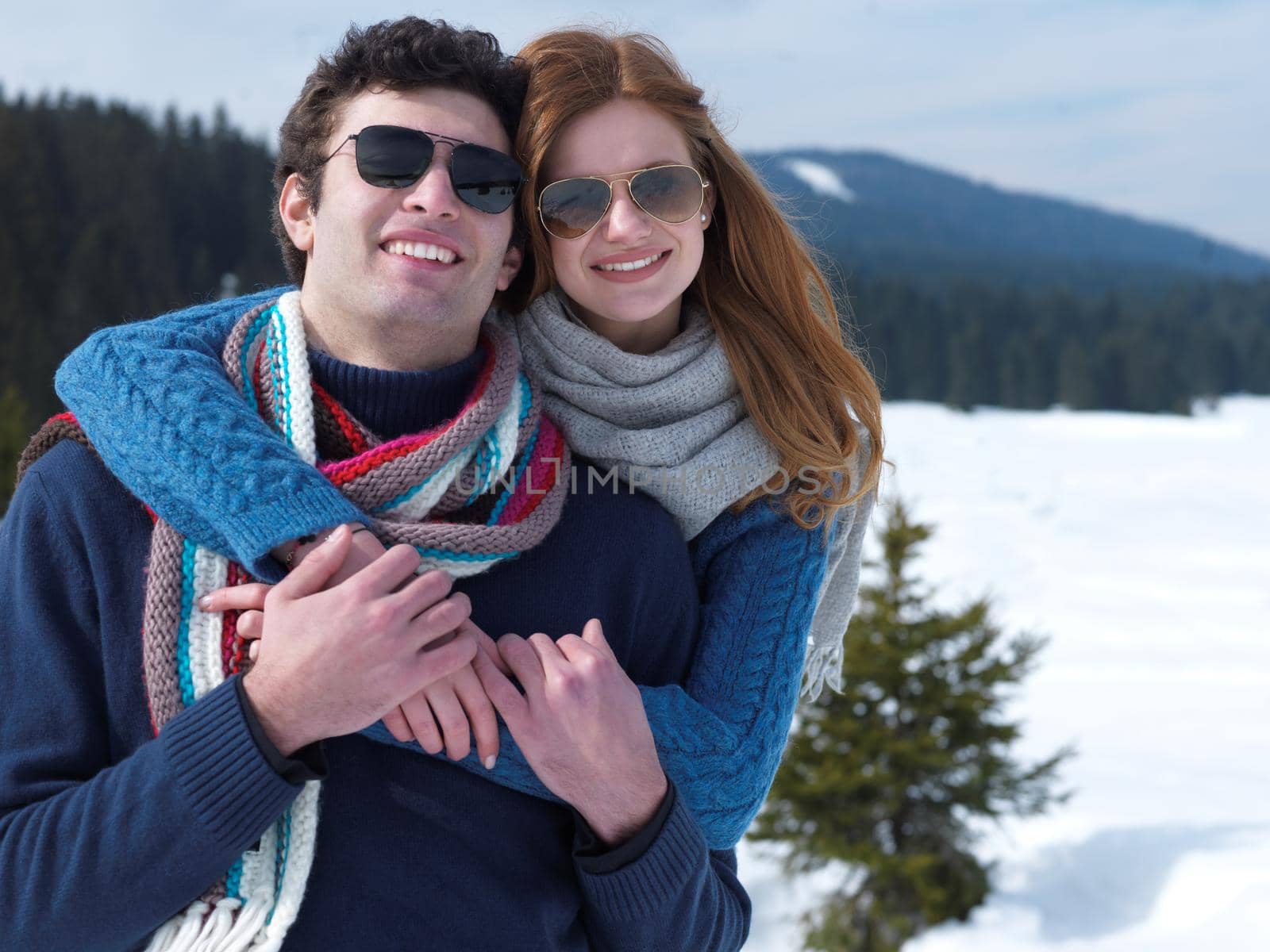 romantic winter  scene, happy young couple having fun on fresh show on winter vacatio, mountain nature landscape