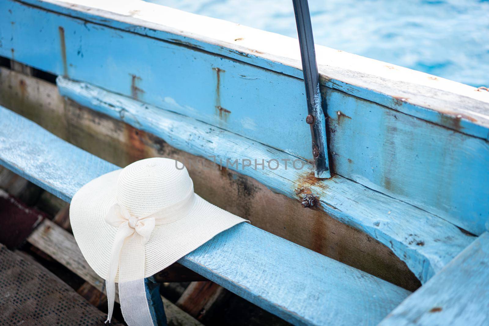 Summer beach hat on old boat no people