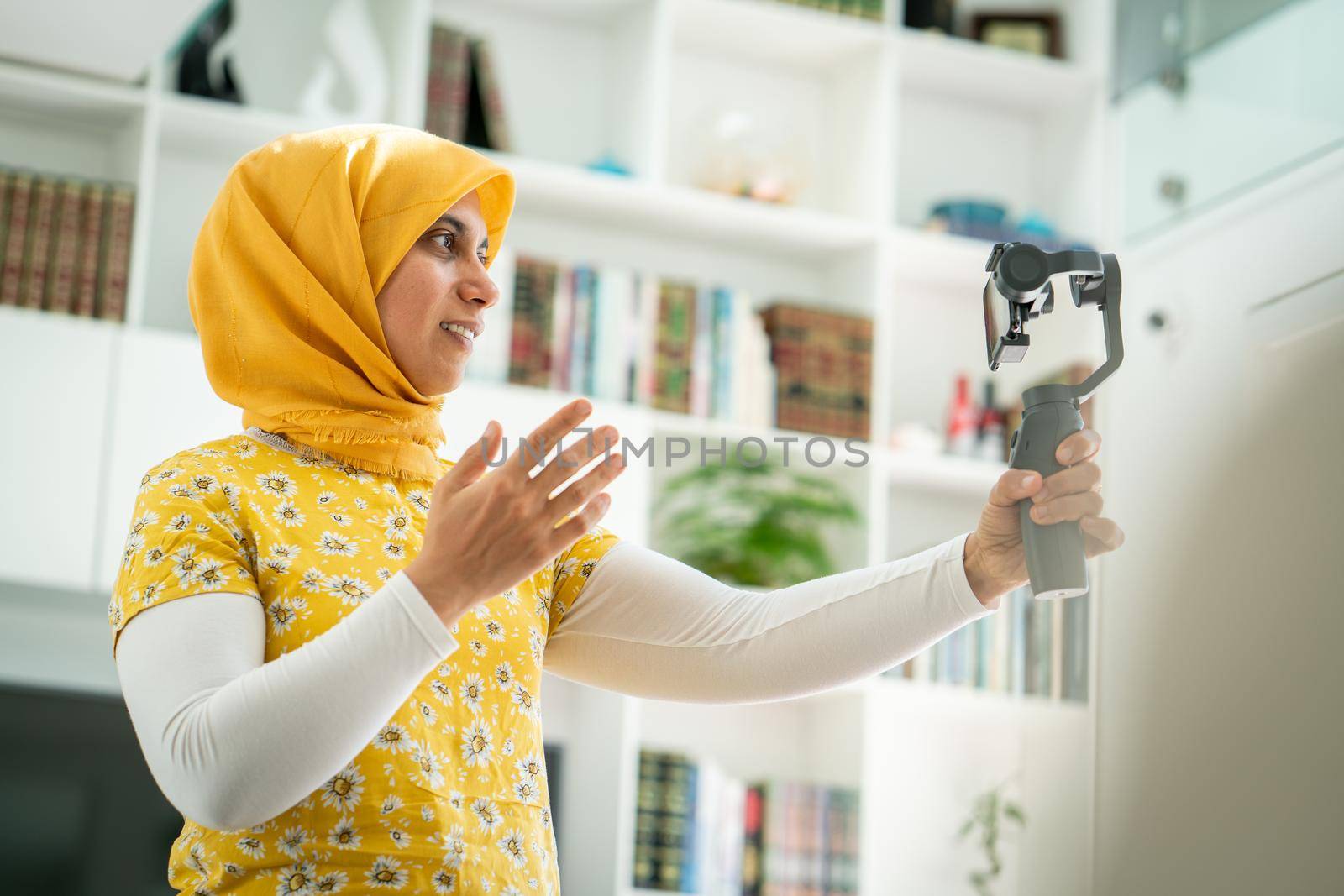 Muslim woman streaming video content online at home