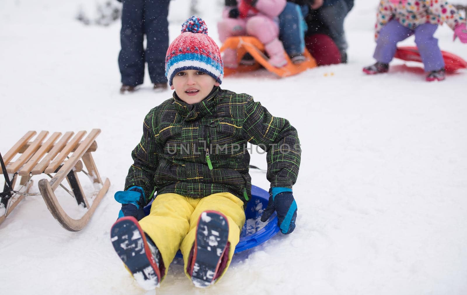 group of children having fun and play together in fresh snow on winter vacation