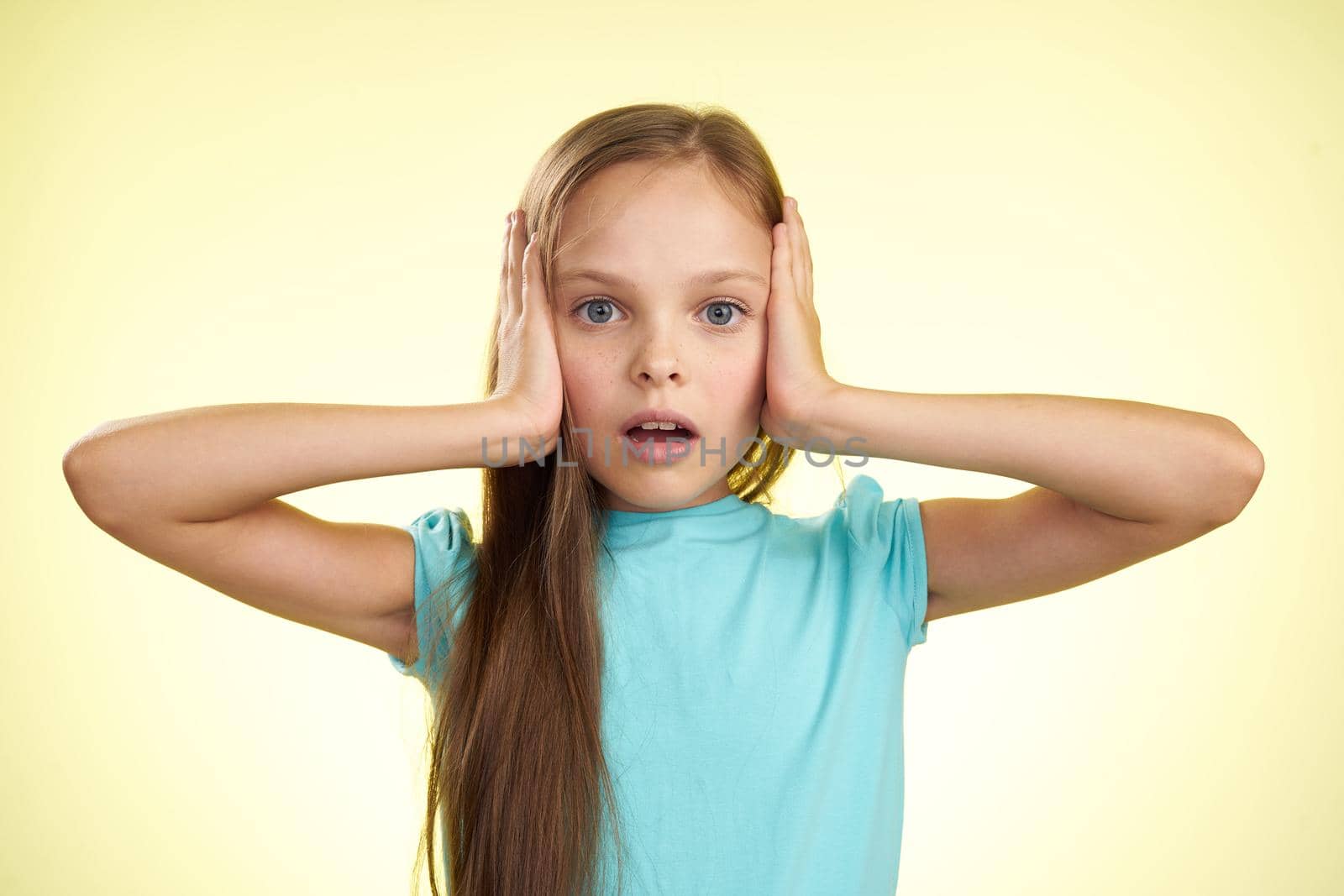 cheerful little girl with long hair close-up studio posing. High quality photo