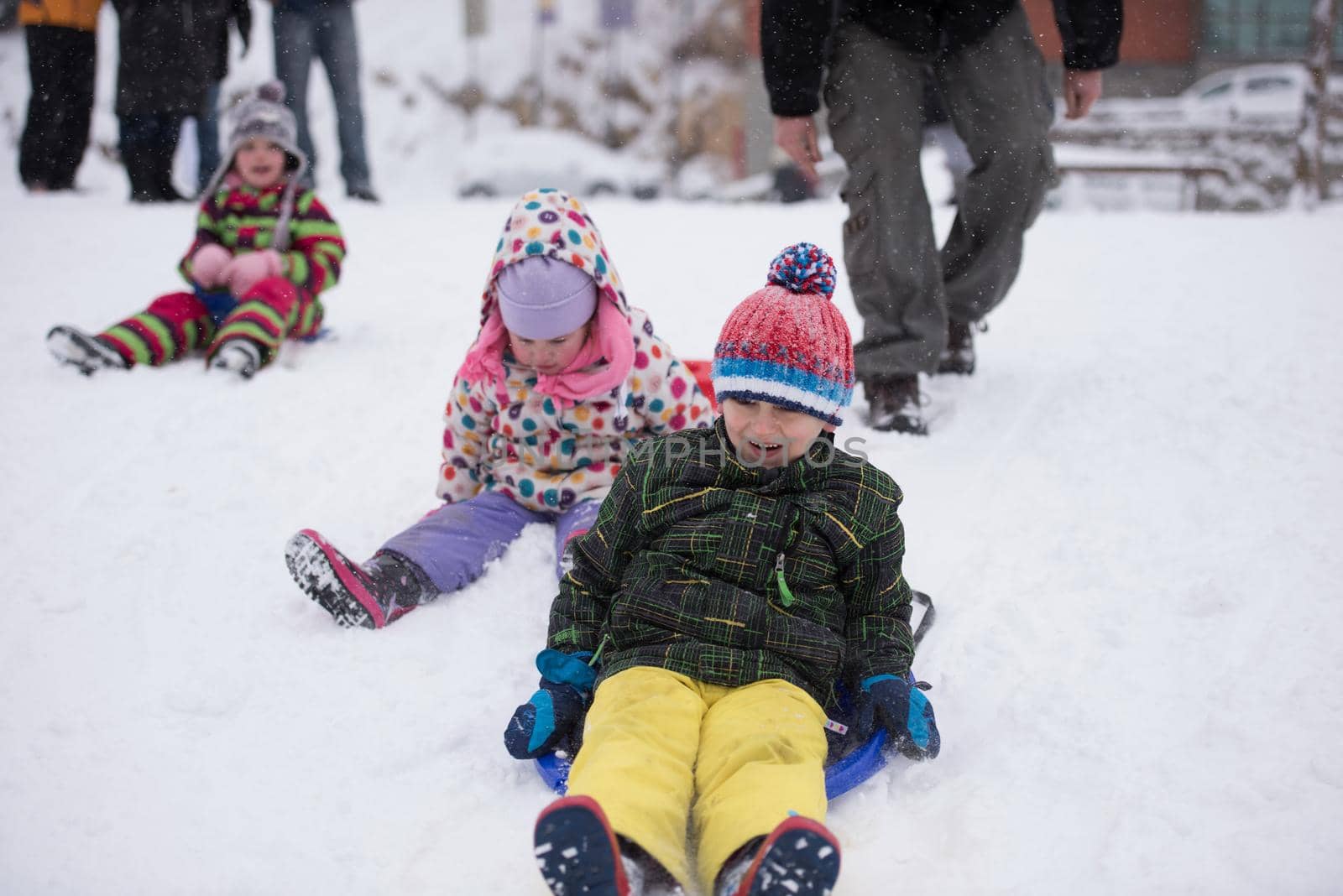 group of kids having fun and play together in fresh snow on winter vacation