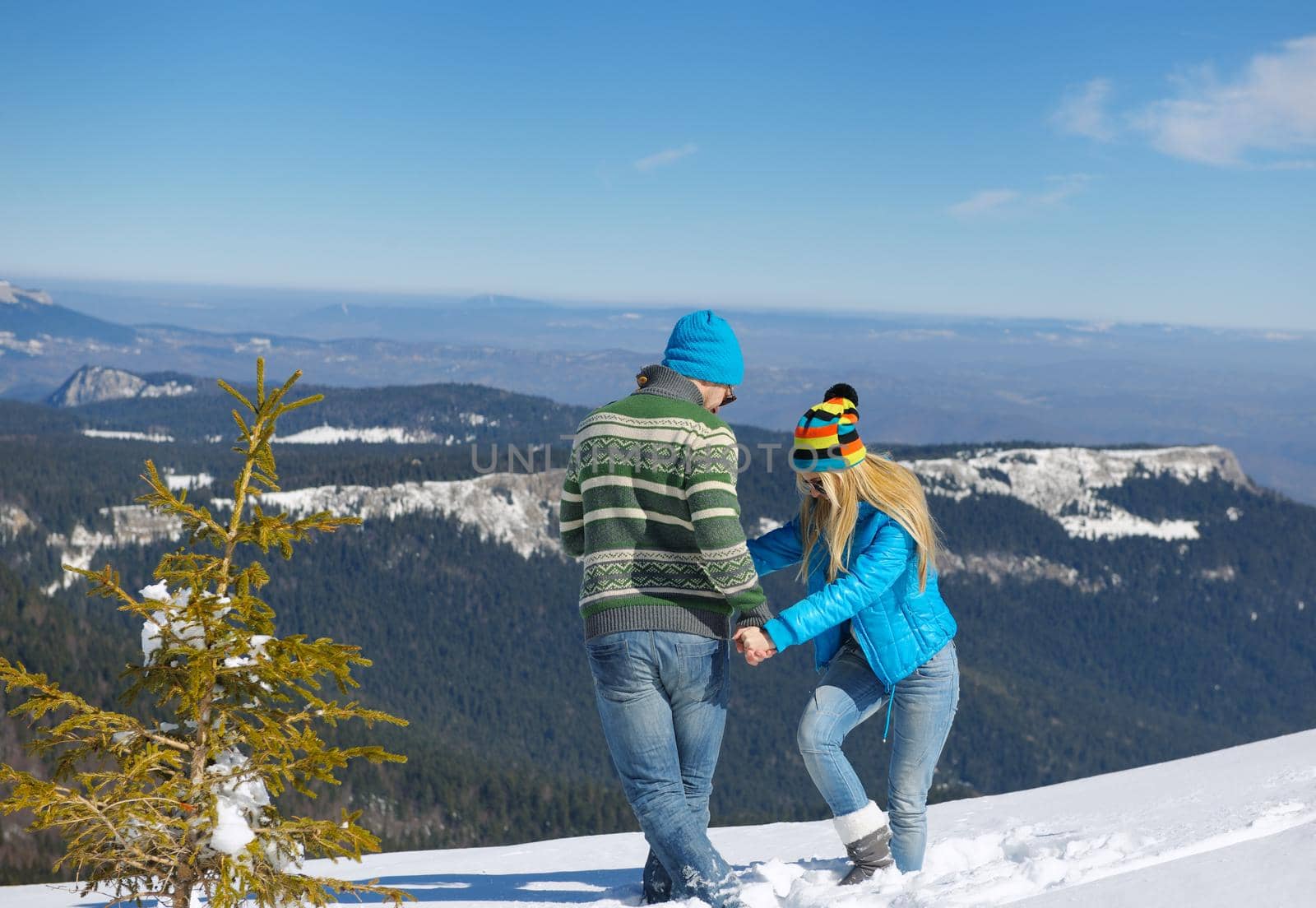 Young Couple In winter Snow Scene at  beautiful sunny day