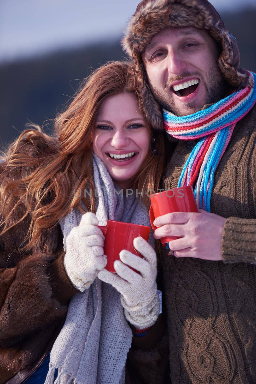 couple drink warm tea at winter by dotshock