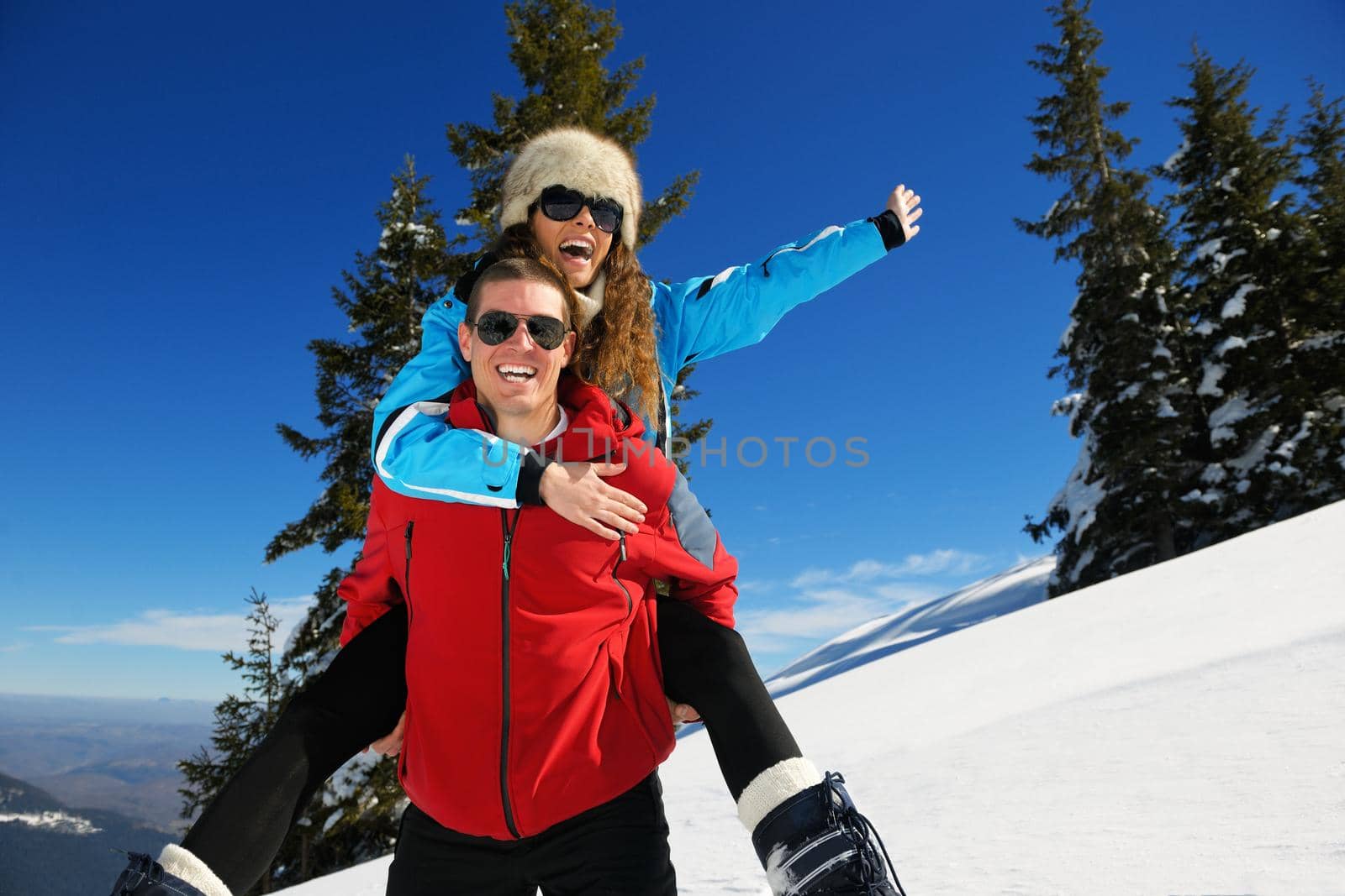 Young Couple In winter Snow Scene at  beautiful sunny day