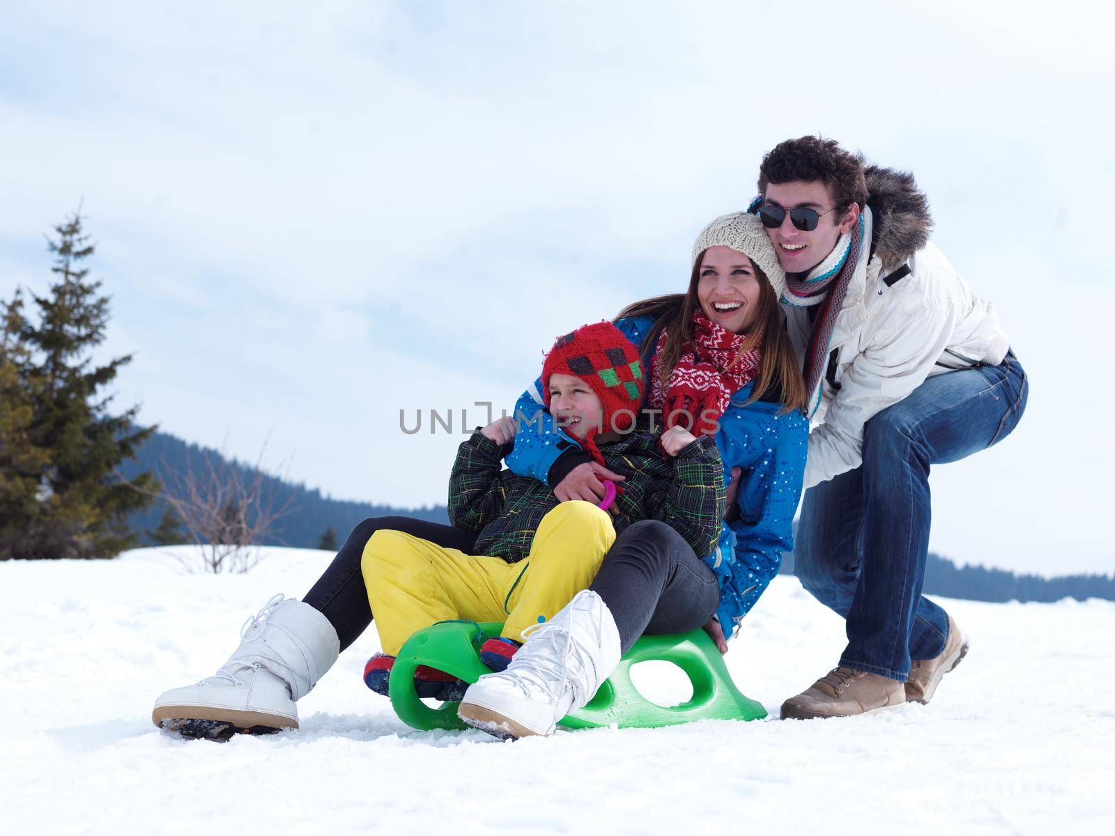 Winter playing, fun, snow and family portrait  sledding at winter time