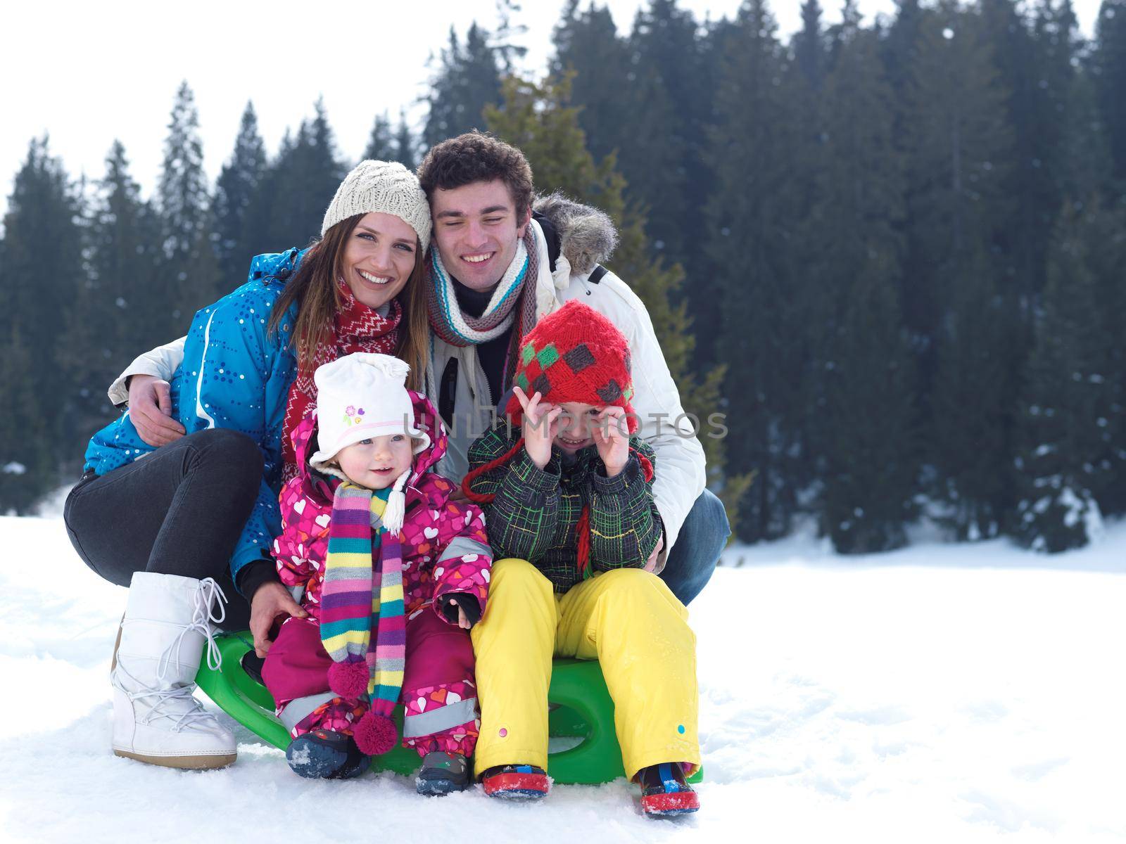 Winter playing, fun, snow and family portrait  sledding at winter time